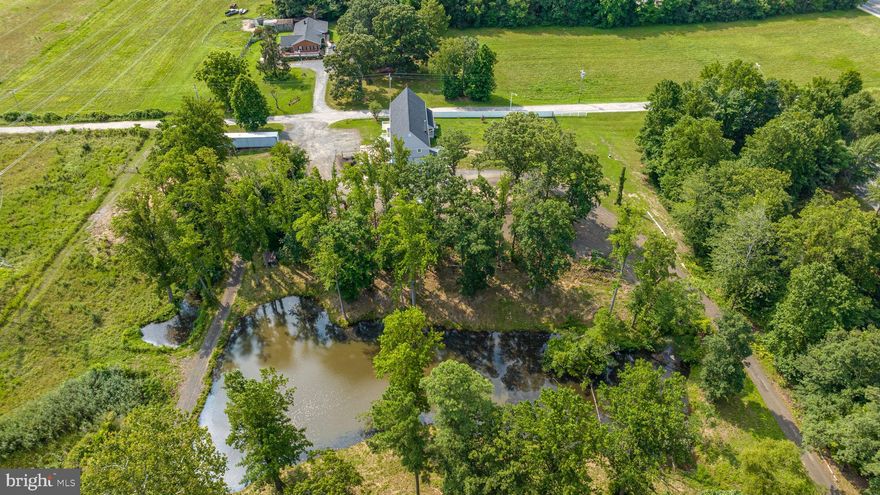 Opportunities like this don’t come along often.
Set on 10 acres in Saint Leonard, this three-unit barndominium offers a rare chance to live, earn, and create something that fits your life. Whether you’re looking to house hack, bring multiple generations together with true separation, or run a business from home, this property gives you the flexibility to do it.
Inside, you’ll find 3,600 square feet of updated living space, thoughtfully divided into three private units. Each has its own entrance, kitchen, living area, and bath, making it easy to live in one while the others generate income, or give everyone their own space without sacrificing privacy.
Unit one offers two bedrooms and one bath. Units two and three each feature one bedroom and one bath. The interiors have been refreshed with new kitchens, bathrooms, flooring, paint, and a new roof, so you can move right in or start renting immediately.
Step outside and the setting takes over. Two ponds, open land, and wide views create a sense of space and calm that’s hard to find. The large patio and front porch invite you to slow down, while the oversized garage, workshop, and separate barn give you room to build, store, or grow a business.
Zoned mixed-use in the town center, this property opens the door to a variety of uses. Buyers should confirm specific plans with Calvert County, especially if considering additional building on the land.
Located just minutes from the heart of Saint Leonard, with an easy drive to Washington DC and Patuxent River Naval Air Station, you get the balance of privacy and convenience.
Live in it. Rent it. Share it. Build something bigger from it.
This is more than a property. It’s a setup for how you want to live next.