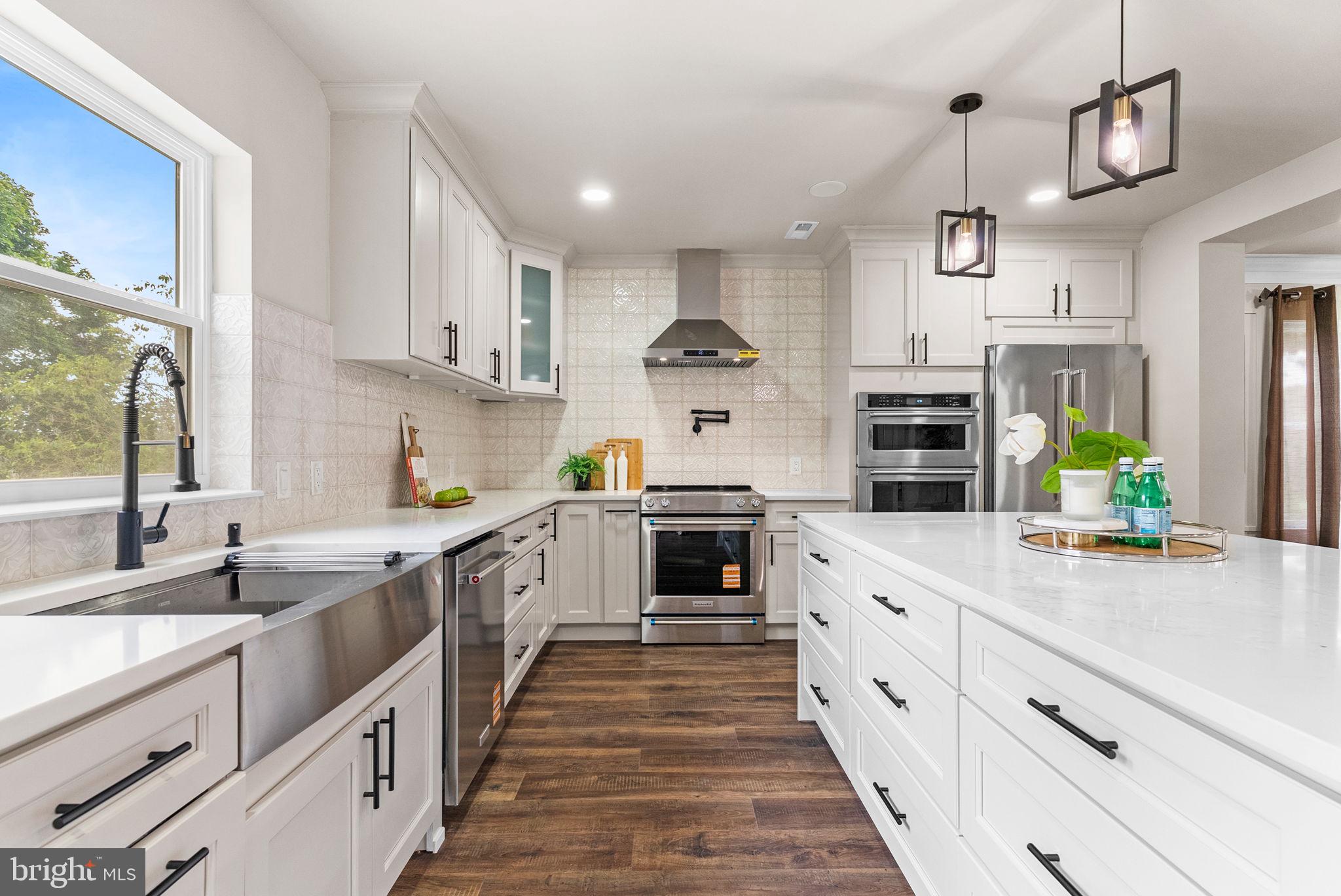 **Open House September 7th Sunday 1-3**. New Built | Move-In Ready! Welcome to 224 Orchard Lane—built from the ground up by a master Amish craftsman onsite, where timeless artistry meets modern sophistication. Every inch reflects uncompromising quality, from the precision millwork to the designer lighting plan, creating a home as functional as it is breathtaking. Perfectly set on nearly an acre in the sought-after Souderton School District, this property offers the rare combination of PUBLIC WATER AND PUBLIC SEWER, no HOA, and a serene setting alongside a picturesque neighborhood of mature trees—ideal for peaceful walks and friendly connections. With an existing Tax ID, you’ll enjoy the benefits of new construction living without the new construction tax rate.
Designed for flexibility, the 5-bedroom, 4-bath layout includes three true primary suites, each with a spa-inspired en-suite bath—ideal for multi-generational living or hosting guests in complete comfort. The professionally landscaped grounds are illuminated with LED pathway and accent lighting, enhancing curb appeal day and night. Out front, a spacious maintenance-free patio with a sleek metal roof cover offers year-round enjoyment, while the expansive 30' x 18' rear patio opens to the private backyard—perfect for gatherings both grand and intimate.
Inside, the dramatic TWO-STORY FOYER is bathed in natural light and anchored by a custom Heritage-style staircase with metal balusters, blending classic elegance with contemporary flair. Wide-plank engineered hardwood floors flow throughout the open-concept main level. The great room features soaring vaulted ceilings and a striking 72-inch stacked stone electric fireplace. The GOURMENT kitchen is a chef’s dream, boasting two-tone custom cabinetry, quartz countertops, a professional burner range with pot filler, stainless hood, wine cooler, oversized 36-inch sink framed by a picture window, and an expansive walk-in PANTRY. Bluetooth speakers in the kitchen and dining areas add a touch of modern luxury.
The MAIN LEVEL GUEST suite offers a private full bath with double vanity and walk-in shower—ideal for overnight visitors or a dedicated home office. A mudroom with custom built-ins connects directly to the oversized 3-car garage, finished with recessed lighting, trim detailing, and an extended driveway with parking for 4+ additional vehicles.
Upstairs (TWO PRIMARY SUITES), the luxurious primary suite is a true retreat, featuring large windows, a spacious walk-in closet, and a spa bath with dual vanities, soaking tub, and glass-enclosed shower. A second en-suite bedroom also offers its own full bath and walk-in closet, while two additional bedrooms share a beautifully appointed hall bath. The second-floor laundry adds convenience to everyday living.
The walk-up FINISHED basement offers endless possibilities for a home theater, gym, or recreation space. All of this is perfectly located with quick access to major highways, upscale dining, and boutique shopping in Collegeville, Blue Bell, and charming Skippack Village, with Center City Philadelphia less than an hour away.
PREMIUM PACKAGE: Upgrades include designer trim and crown molding package, recessed and landscape lighting, engineered hardwood floors throughout, and ceramic tile bathrooms, gourment kitchen. The primary suite offers a custom walk-in closet, plus premium doors, two HVAC systems, and brand-new public water and sewer lines.
224 Orchard Lane isn’t just a home—it’s a masterclass in craftsmanship and a statement in luxury living.