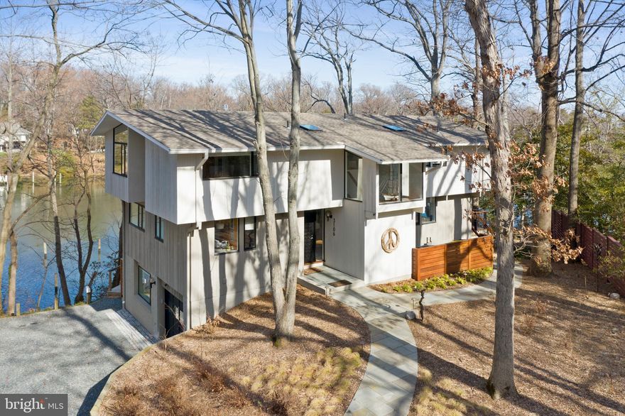 Annapolis Waterfront Jewel on Lake Ogleton with 150+ ft. of shoreline and a private dock, deep water (6ft.MLW) with 4-boat slips.   Direct access to the Chesapeake Bay and the Severn River.  This completely renovated Mid-Century Modern home has water views from nearly every room and a wrap around 180 degree IPE deck.  Stainless steel railing for unobstructed views throughout.  Move-in-ready, 4,000 sq.ft. of living area, 4-bedrooms, 3-bathrooms and recreation space for home office, gym and family room.  Completely gutted and renovated in 2017 - from new roof (2021), to windows and hardwood floors.  Custom built and exquisitely decorated.  A must see!