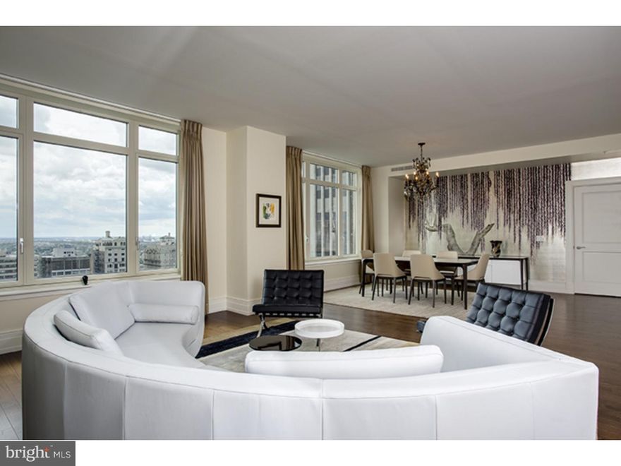 On a high floor with direct views of Rittenhouse Square, this superbly finished three bedroom, 4.1-bath 3693 square foot residence has been impeccably maintained. Step into a dramatic great room with living and dining areas featuring custom designed Robert A.M. Stern windows with grand views of the park and its lush greenery. The open-plan kitchen/family-living area is pristine with all top-grade finishes, including Poggenpohl cabinetry, Sub-Zero refrigerator, Sub-Zero wine chiller in the butler's pantry, two Miele dishwashers, Miele wall ovens, Miele cooktop and a Viking hood. Start your day overlooking the Square from the breakfast area with a three-sided floor-to-ceiling window. Rich walnut floors run throughout these living spaces. Private quarters include a sumptuous main bedroom suite with two bonus features: his and hers luxury Carrara marble baths each with frameless showers and a BainUltra Airtub in "her" bath, and separate walk-in closets. It also includes a den with beautifully designed built-ins. There are two additional bedrooms each with a full bath. The laundry room is located just off the butler's pantry and includes a Miele washer and dryer. 10 Rittenhouse is a full-service concierge building with doorman, chauffeured car, fitness center, gym and an array of services for residents. This residence includes garage parking for two cars.