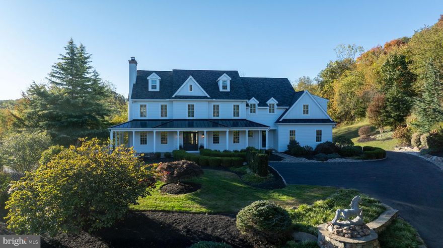 Set back on a tree-lined driveway amid 4 peaceful acres, this stunning 4,764-square-foot Chester Springs estate blends timeless architecture with modern comfort and thoughtful upgrades throughout.

A grand entrance welcomes you into an open, light-filled home that radiates warmth, charm, and sophistication. The inviting wraparound porch, overlooking a tranquil water garden and Koi pond, sets the tone for a lifestyle of serenity and connection—perfect for morning coffee, evening sunsets, or quiet reflection surrounded by nature.

Inside, you’ll find five spacious bedrooms and four full plus two half bathrooms, including a luxurious master suite with his-and-her closets and spa-inspired finishes. The brand-new designer kitchen shines with custom cabinetry, premium countertops, and high-end appliances—beautifully designed for both daily living and entertaining.

The main level also features a library/home office, offering an ideal space for reading, working, or study. From the adjoining living area, step through French doors onto a private outdoor patio, perfect for gatherings or peaceful evenings outdoors.

The finished basement includes a wet bar and generous open space for recreation, fitness, or guest accommodations—ready to adapt to your lifestyle.

Outside, enjoy a beautiful pool and patio area, framed by mature landscaping and complete with connections for a pool heater. The wrought-iron garden pavilion provides a storybook setting for relaxing, reading, or simply enjoying the serenity of your surroundings.

Additional highlights include a comprehensive security system with automatic fire alarm, a brand-new roof with a 50-year limited warranty, brand-new siding, and a three-car garage.

There are simply too many details to mention—this extraordinary property must be seen to be fully appreciated.