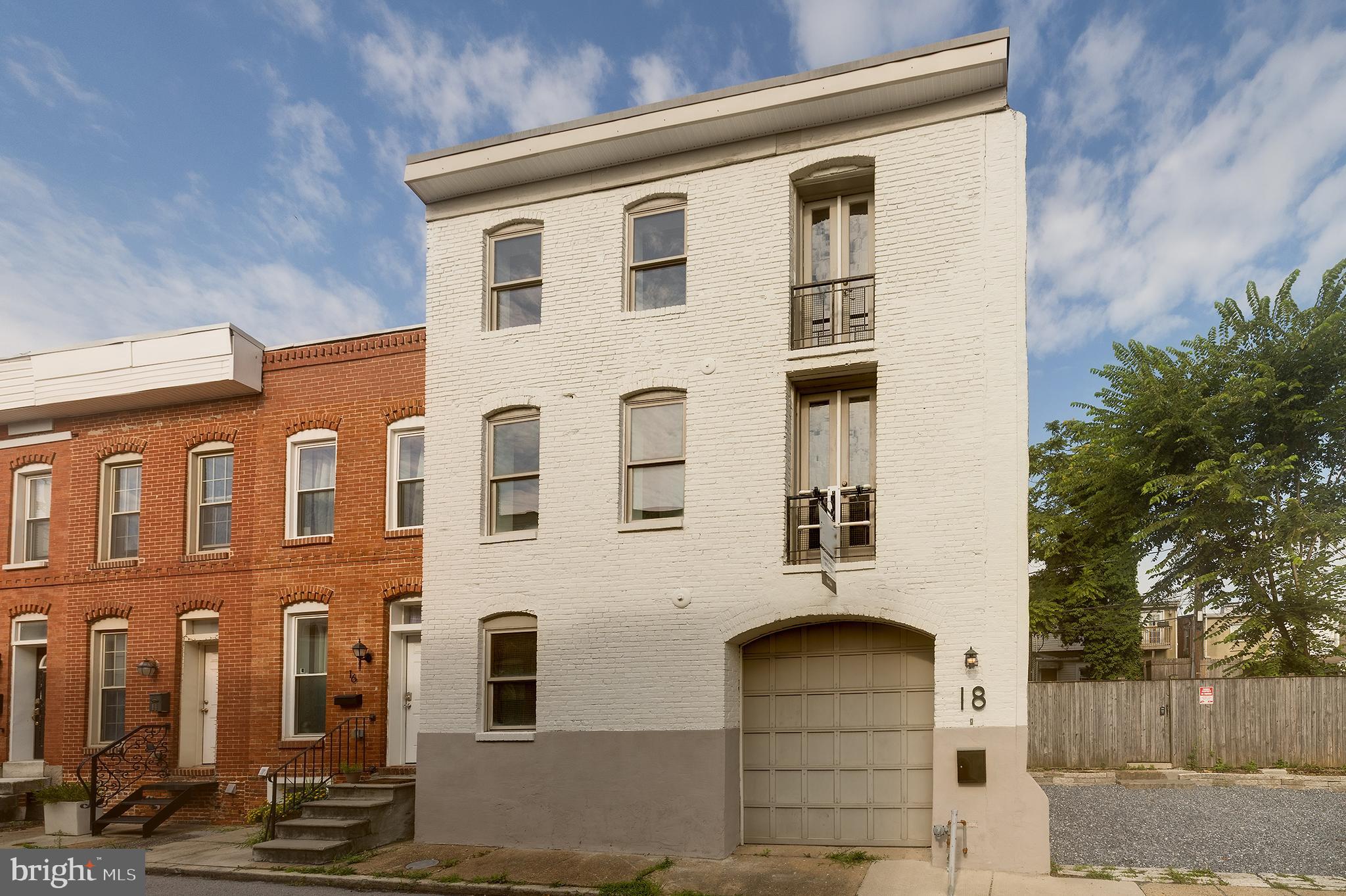 Incredibly rare and unique opportunity to own a stunning end-of-group 1920s carriage house, once a police station, just one block from Patterson Park! Brimming with historical charm, this spacious home showcases original hardwood floors and an expansive footprint—measuring an impressive 28 feet wide by 55 feet deep—making it one of the largest homes on the block. An additional lot (20 N), offering extra parking, a private courtyard, or a prime opportunity to expand the property’s footprint is available for purchase as well. The ground level features a four-car garage, with part of the space currently being converted into an apartment. However, the seller is open to restoring the full four-car garage if preferred. With abundant square footage, historic character, and unparalleled parking, this is a truly exceptional opportunity in one of Baltimore’s most desirable locations!