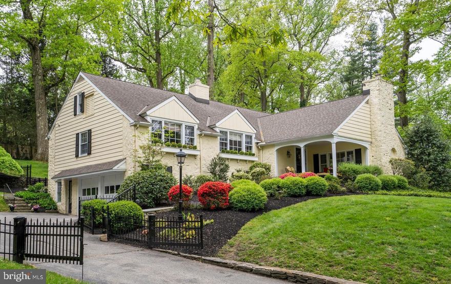 The comforts of home are all yours in this stunning, meticulously maintained and upgraded Main Line home in coveted Northside Bryn Mawr! A long private drive with gated entry leads to a 2-car garage and plenty of parking for family and guests. Gorgeous grounds are pristinely landscaped and brimming with tall trees and specimen plantings. The expansive backyard is fully-fenced for the safety of kids and pets, and a lovely new rear patio affords outdoor entertaining and enjoyment. There’s even invisible fencing front and back so Fido stays close to home!  A breezy covered front porch welcomes you to this charmer and provides a peaceful spot to relax and enjoy the views. You’ll love the gracious interiors of this finely-updated gem that enjoys tons of natural light, beautiful hardwood floors, tasteful millwork & woodwork, met by modern finishes throughout generously-sized rooms. Host guests with ease in the large living room with fireplace brightened by a wall of windows. The formal dining room with oversized windows is an elegant backdrop for sharing meals and special occasions. Any cook will adore the hub of the home, the top-of-the-line gourmet kitchen appointed with Wolf, Bosch and Thermador appliances, a wine cooler, center island with seating for gathering around, and breakfast bench nook for morning coffee. Adjoining is an open family room with striking fireplace, and French doors to the back patio for seamless indoor-outdoor living.     In the separate bedroom wing 4 steps up, your inviting primary bedroom retreat awaits, providing a luxurious place to land. Freshen up in style in the updated spa-like en-suite bath featuring radiant heat floors, a towel warmer, soaking tub and frameless glass shower. 2 Additional bedrooms access a nicely renovated full hall bathroom. The airy upper level offers a guest suite with full bath and an incredible playroom/sitting room/office space or 5th bedroom with decorative fireplace. Plus, there’s a spacious walk-in storage attic, and fully-waterproofed lower level with a new washer & dryer, sink, storage, and entry to the garage.  Many other highlights include an underground drainage system, new lower roof, new Marvin windows, new Marvin sliding patio door, new front gutters, new garage doors, Hunter Douglas hurricane shades, new 2nd electrical panel, EZ Breath home air filtration system, and new wireless ADT security system. Best of all is the prime location near shopping, dining, transportation, and award-winning Lower Merion schools!