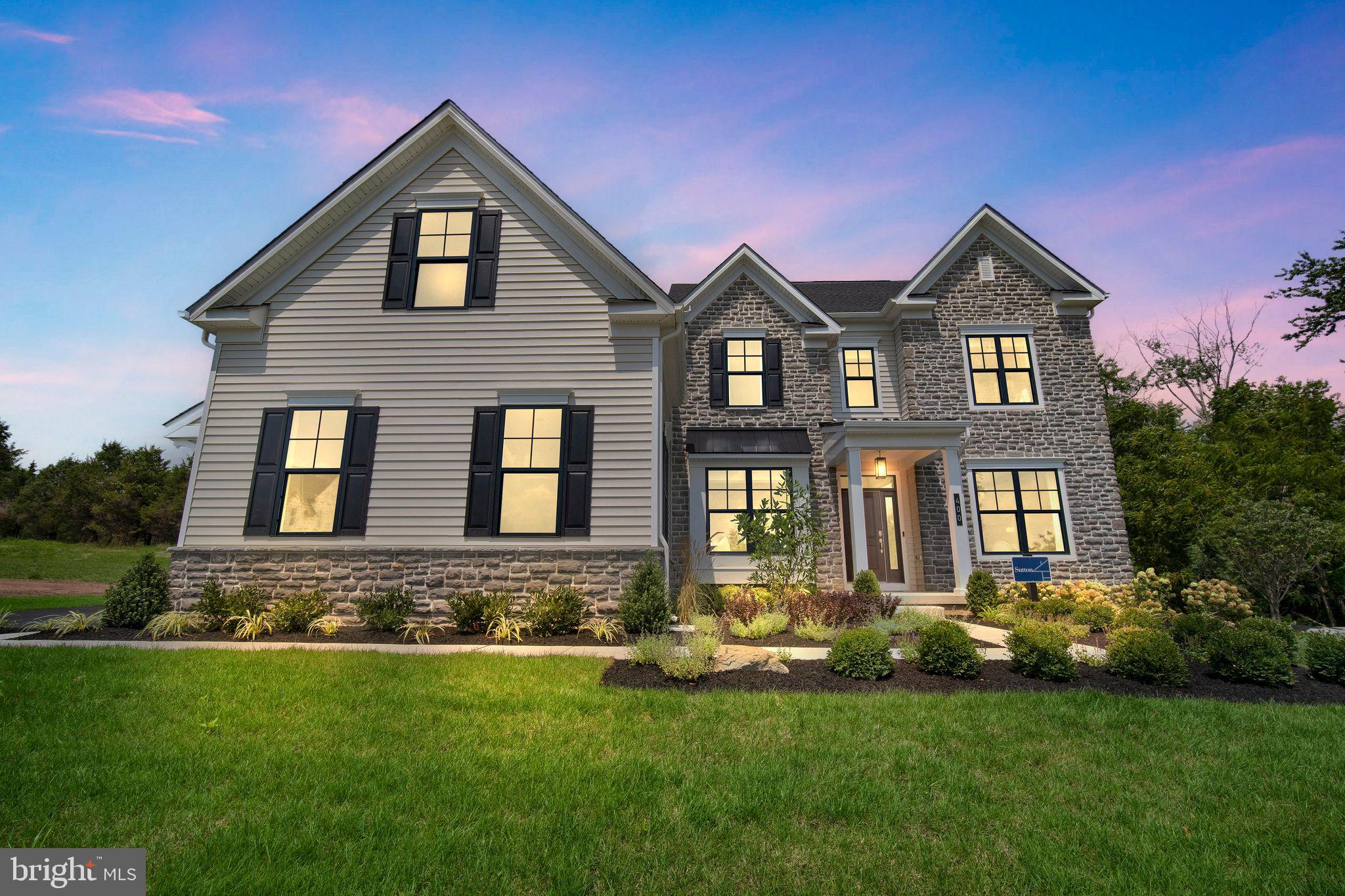 The Sutton floorplan features an impressive 4+ bedrooms, 3.5+ bathrooms, plentiful flex space, and so much more across its spacious 3,700+ sq. ft. of living space. Entering the home from the covered front porch, you are met by a welcoming foyer with tray ceiling that seamlessly connects to the formal dining room & private study. Airy 9' ceilings are found throughout the home, guiding you into the main living area comprised of a chef-inspired kitchen, eat-in breakfast area, and voluminous 2-story great room. This oversized kitchen is designed to entertain with its plentiful cabinetry, gorgeous quartz countertops, ceramic tile backsplash, dramatic central island, walk-in pantry, gleaming stainless steel appliances. Also found on this level is a convenient flex room, perfect for a private office or can even be converted into a 1st floor guest suite! Nearby, a convenient mudroom offers access to the 2+ car garage and laundry room. Moving upstairs to the 2nd floor, you'll find double doors that lead you into the restful owner's suite, complete with 2 walk-in closets & a luxurious owner’s bath with dual sink vanity with gorgeous quartz countertops, private water closet, & spacious shower with bench seat. Also on this level are three additional bedrooms, one with an attached bathroom, & an additional full bath with double sink vanity. Fall in love with the extensive personalization that this dreamy floorplan offers, such as finishing the 9' basement, adding a deluxe guest suite or rear covered porch, and so much more to truly create your dream home. Estates at Maple Ridge, built by W.B. Homes, offering the area's best value luxury single family homes in the East Penn School District. Perched on a hillside with stunning skyline views and wooded space in every direction.