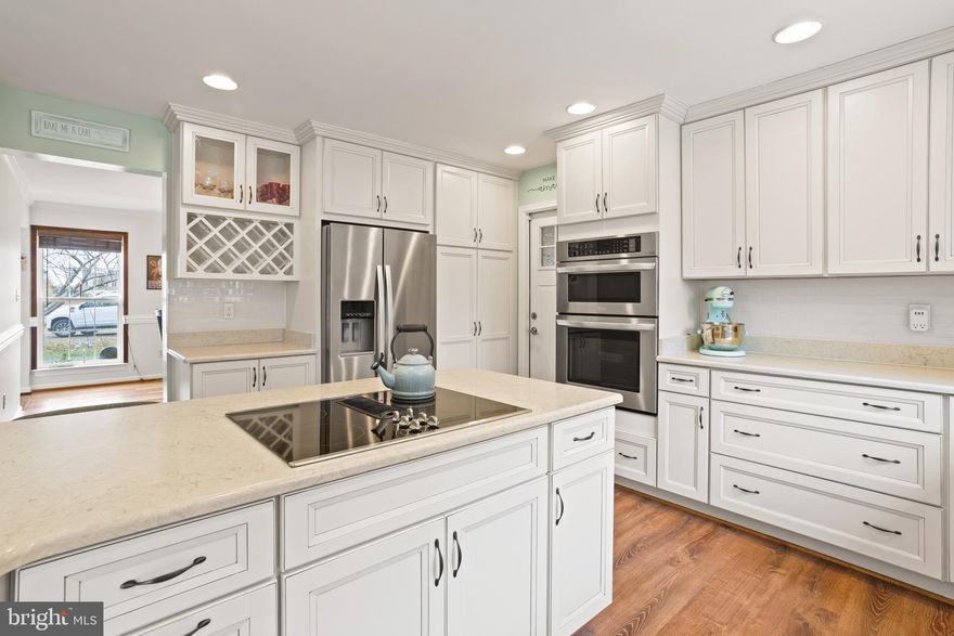 A beautiful setting with a circular driveway, lots of privacy and beautiful landscaping! The kitchen was fully remodeled in 2019, complete with new appliances, gorgeous countertops, and cabinetry loaded with smart built-ins—both beautiful and incredibly functional. The family room sits just off the kitchen and offers a cozy gas fireplace. The dining room, foyer, and home office/living room all feature updated hardwood floors and lighting. A newly renovated half bathroom on the main level. Upstairs, you’ll find a newly renovated full hall bathroom and four bedrooms. The smallest one serves as a large laundry room; however, can easily be converted back!  The partially finished basement includes a full bath, abundant storage with built-in shelving, and a full walk-out to the side yard. Serving as a man cave/music room currently, this lower level offers so many possibilities- a playroom, work out area, office or recreational room ! The home is equipped with 3-zone heating and cooling, including an upgraded geothermal HVAC system. Thanks to this efficiency, the average electric bill is just $223. Off of the beautiful Kitchen you walk out to a 16x20 composite deck overlooks peaceful surroundings with deer, birds and beautiful landscaping. And while the garden may be resting now, the spring and summer blooms around the property are truly breathtaking. This 2.4 acre lot offers plenty of space to make your own. Previous owners secured a permit for a future 28x24 detached garage, giving the next owner the option to add one later.