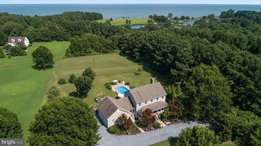 Tucked away at the end of a picturesque crepe myrtle–lined drive, this exceptional waterview retreat offers a rare combination of privacy, scenic beauty, and convenience, all just moments from the charm of St. Michaels and Easton.

Set on a peaceful, tree-lined parcel overlooking Black Walnut Creek, with glimpses of the Chesapeake Bay beyond, this property delivers a true sense of escape. Whether you are seeking a full-time residence, a weekend getaway, or an income-producing short-term rental, the setting and lifestyle here are simply unmatched. Even better, there is no HOA, allowing you the freedom to fully enjoy and personalize your property.

Located in FEMA Flood Zone X, with no history of water intrusion, this home provides both peace of mind and long-term value in one of the Eastern Shore’s most desirable destinations.

Inside, thoughtful design meets everyday comfort. The home welcomes you through a gracious front foyer, while a secondary mudroom entrance, complete with laundry, utility sink, storage, and a full bath, offers the perfect transition after days spent poolside or on the water.

The main level is designed for both relaxed living and effortless entertaining, featuring multiple inviting spaces including a refined parlor with custom built-ins and a warm, welcoming family room anchored by a wood-burning fireplace that extends to the second level for added efficiency. Sliding doors open seamlessly to the outdoor living areas, creating an easy indoor-outdoor flow.

At the heart of the home, the kitchen is both functional and stylish, featuring granite countertops, light wood cabinetry, stainless steel appliances, and a breakfast bar. Just beyond, a spacious deck and patio overlook the in-ground pool, offering an idyllic setting for summer gatherings or quiet evenings under the stars. A formal dining room provides views of the front grounds, perfect for more intimate occasions.

Upstairs, three well-appointed bedrooms include a spacious primary suite complete with a walk-in closet, additional linen storage, and a private en-suite bath featuring a jetted soaking tub and double vanity. A versatile bonus room offers flexibility as a fourth bedroom, home office, or creative space.

Outdoors, the property truly shines. Multiple seating areas surround the in-ground pool, all framed by tranquil water views and natural landscaping. Both attached and detached garages provide abundant space for vehicles, hobbies, and storage, while the fully concreted crawlspace adds even more functionality.

For those drawn to life on the water, several nearby public boat launches and a convenient kayak launch just down the street make it easy to explore the surrounding waterways and the Chesapeake Bay.

Additional features include dual security systems, fire and carbon monoxide detection, and a custom exterior camera system, offering comfort and peace of mind.

This is more than a home. It is a private Eastern Shore retreat designed for those who value space, serenity, and connection to the water.

Schedule your private showing and experience it for yourself.