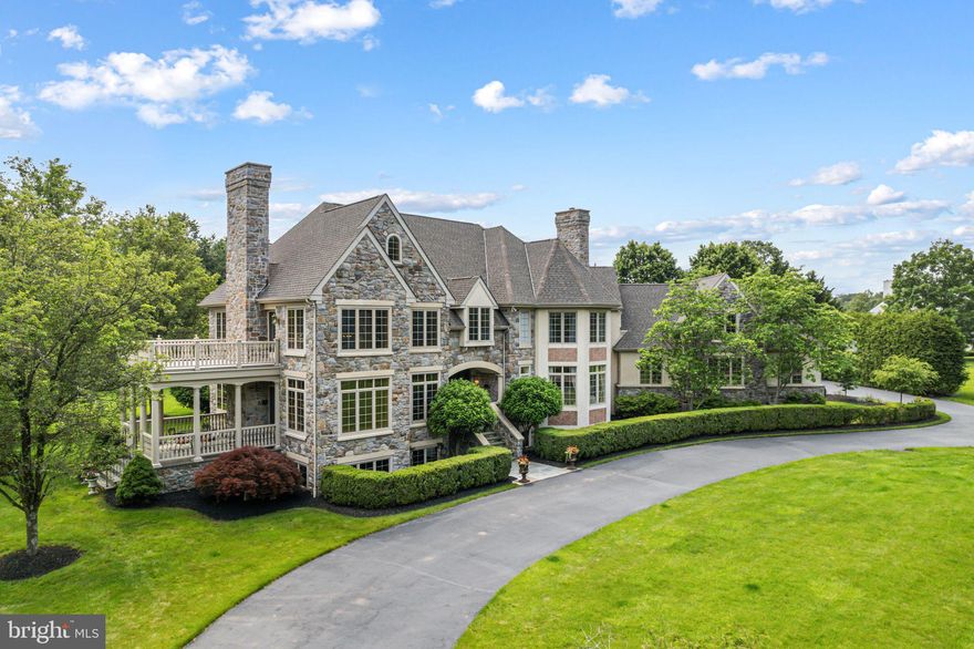 Welcome to your dream home! This exceptional Guidi custom-built estate, a luxurious 6-bedroom, 5.2-bath residence nestled on a stunning double lot spanning over 2 acres in one of Lower Gwynedd’s most coveted neighborhoods, Polo Club Estates. This extraordinary home exemplifies refined elegance, beginning with a professionally landscaped grand entrance, a circular driveway, new roof and a stately paver walkway leading to a covered front entry.
Inside, the marble foyer opens to a sweeping staircase and exquisite imported Murano doors from Italy, guiding you into a dramatic two-story living room. Rich millwork, a custom gas fireplace mantle, and floor-to-ceiling decorative moldings evoke timeless sophistication. Lower terrace with large columns and flagstone pavers off living room. Upstairs, a magnificent library adorned with custom built-ins and ambient lighting offers access to a private upper-level terrace.
A striking 125-gallon see-through freshwater aquarium stylishly separates the sunken family room—featuring recessed lighting, a wood-burning fireplace, and sliding doors to a screened-in slate porch. The gourmet kitchen is a chef’s dream, complete with tile floors, granite countertops, custom cabinetry, a spacious center island, dual dishwashers and ovens, a six-burner cooktop, and a built-in custom  refrigerator. The adjoining breakfast room, with its soaring ceiling and expansive windows, offers scenic views of the porch and gardens.
A butler’s pantry connects to the elegant formal dining room, graced with hardwood floors, intricate moldings, a marble gas fireplace, and an abundance of natural light from oversized windows. A recent renovation transformed the private home office, now featuring hardwood floors, recessed lighting, and double French doors. Additional main-level amenities include a full bath, a powder room with a pedestal sink, and a spacious laundry room with a built-in desk, all offering easy access to the attached three-car garage with custom built garage doors.
Upstairs, the expansive primary suite is a true retreat, with cathedral ceilings, generous windows, a cozy fireplace, and a custom walk-in closet. The luxurious en-suite bath includes dual vanities, a large, tiled shower, a Jacuzzi tub, and abundant natural light. Four additional upstairs bedrooms, each with plush carpeting and ample closets, enjoy the privacy of their own en-suite baths. A spacious sixth bedroom on the third-floor features high ceilings and generous storage.
The newly finished lower level is designed for entertaining, boasting high-end resilient flooring, a full bar with pendant lighting, high ceilings, space for a pool table, a cozy lounge area, and a stylish half bath. Behind the barn doors this expansive basement offers the ideal footprint for a custom golf simulator setup. With generous ceiling height, ample floor space, and minimal obstructions, it’s a dream space for golf enthusiasts seeking a private, year-round practice environment.
Outdoors, the expansive EP Henry patio, complete with stone walls and a full outdoor kitchen, sets the stage for unforgettable gatherings. A full basketball court and meticulously landscaped grounds complete this serene and elegant setting. 
Come experience the pinnacle of luxury living in the heart of Lower Gwynedd.