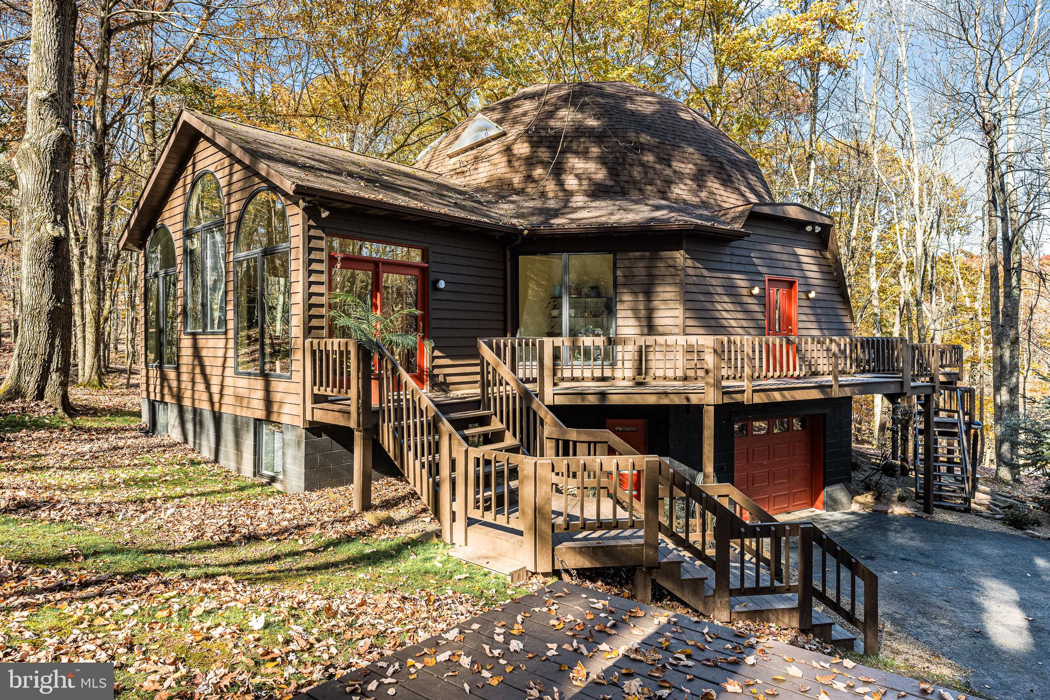 Opportunity to own one of Deep Creek Lake's most unique homes! 621 Paradise Heights is a geodesic dome house offering 4 bedrooms, 3 full bathrooms and over 4300 square feet of interior space. Become the ultimate host of guests with the many entertainment spaces in the house including main level living room, parlor with wet bar, expansive deck, stacked stone fireplace, fit pit in back yard and more. The Paradise Heights location offers close proximity to all of the essential destinations and amenities you are looking for when you come to the lake with a private feel tucked into the hillside. Whether you are looking or a second home, vacation rental investment or primary residence, this home could be exactly what you are looking for. Call today to schedule a private showing!