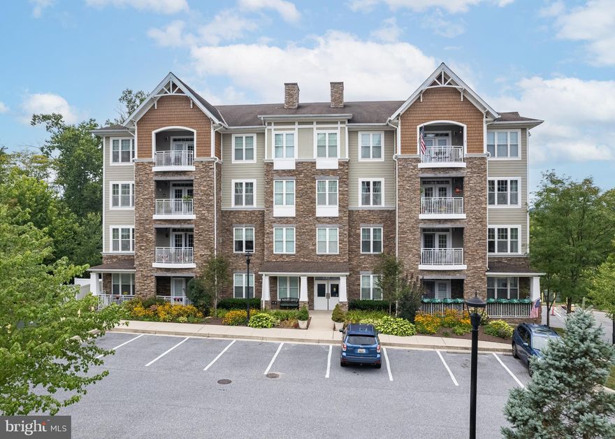 Beautifully set on a hill surrounded by trees this 2 bedroom, den unit, features 2 baths, hardwood flooring throughout, granite counters, breakfast bar, lots of cabinets for storage,  loads of windows throughout the unit brings in the natural light, open floor plan, lends itself to your creativity.  The Primary bedroom has a walk-in closet, 2 additional closets and a linen closet, and a ceiling fan, primary bath has large stand-up shower w/bench and double vanity w/2 sinks and a linen closet. Off the great room is access to a balcony which faces the woods, so peaceful. This home is ready for its new owner. On lower level there is a garage space (#2) and a storage unit (#2). This is a 55+ community with a lovely community building for residents to meet and greet.