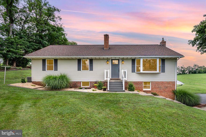 Better than new on a quiet country lot! This beautifully updated 3-bedroom, 2.5-bath rancher sits on a 0.68-acre lot in Rapho Township, just minutes from downtown Manheim and Route 283, offering the perfect blend of rural tranquility and convenient access.

Step inside to discover an expansive open-concept living space highlighted by vaulted ceilings, exposed wood beams, and a cozy gas fireplace. The custom kitchen features upgraded cabinetry, LED under-cabinet lighting, and a spacious pantry, ideal for entertaining or everyday living. A sliding door off the kitchen leads to a covered back patio, redone with new railings, perfect for your morning coffee or backyard gatherings.

Nearly everything in this home has been updated within the last five years, including the hot water heater (under warranty), well pump and filtration system, electric panel with whole-house surge protector, AC unit, furnace, and chimney cap. Enjoy upgraded wooden blinds throughout (including a remote-controlled blind on the front window), stylish ceiling fans, and enhanced lighting.

The main level offers three generously sized bedrooms, including a private primary suite with a custom dual vanity and walk-in stall shower. Downstairs, the finished basement includes a wet bar, offering a cozy entertainment area. You will also find a laundry area with a half bath and access to the oversized 2-car garage with an impressive workshop and a dedicated wall-unit AC, a rare and valuable bonus.

This home has been thoughtfully improved and carefully maintained. The private, tree-lined lot offers space to relax, garden, or play. The upgraded landscaping, and re-mulched beds complete the outdoor oasis.

Do not miss this opportunity to own a move-in ready home that outshines new construction. Schedule your private showing today. This one will not last long.