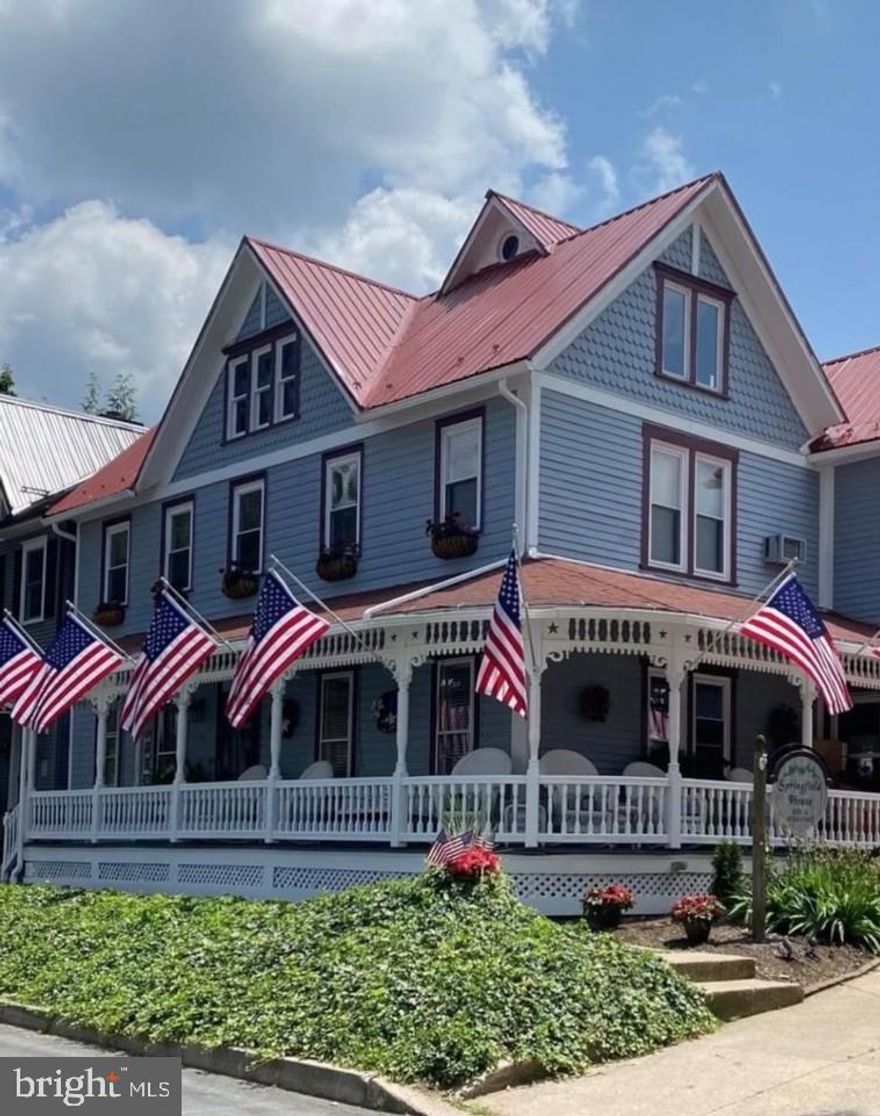 Elegance awaits at the Historic Village of Boalsburg Springfield House Bed and Breakfast! Built in 1847, enjoy historic charm with updated features and bold color flowing throughout! The expansive wrap-around porch provides the perfect opportunity to enjoy the hustle and bustle of downtown Boalsburg or simply enjoy a cup of coffee or a good book shaded by the sun. The park-like backyard features a new paver patio, stone pizza oven, and 1 car detached garage. Boasting over 4,000 finished sqft, inside you'll find plenty of room for you and all guests including 5 individually themed bedrooms, each with its own full bath. The separate owner's suite provides privacy from the main house and features its own bedroom, full bath, and living space.  The adorable carriage house provides an opportunity to have a retail shop, office, or an additional bedroom! More details coming soon including a list of permitted uses, additional photos and a complete list of included items with the purchase of this glorious estate!