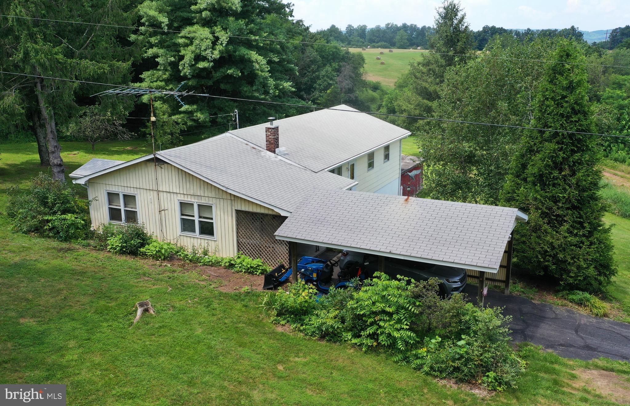 COME TO THE COUNTY! SWEET ONE-ACRE RURAL RETREAT WITH VIEWS OF MOUNTAINS AND MEADOWS. SPACIOUS 3-BEDROOM RANCHER WITH A FULL WALK-OUT BASEMENT, 3 CARPORTS. MORE THAN 1,400 SQUARE FEET ON EACH LEVEL. On a paved road with easy access to Rt. 50. Drive to Augusta and Romney to the west and Capon Bridge and Winchester to the east. On 1.22 acres. Not in an HOA. Large living room and main-level family room. Eat-in country kitchen. Lovely hardwood floors. Updates in 2025 include a heat pump for heating and cooling, electric panel box and electric meter, gutters and gutter guard, pellet stove, and double French doors to the walkout basement. Roof is 7 years old. Water heater 5 years old. Conveys with freestanding kitchen cabinet and all appliances, including washer and dryer. Lots of possibilities for finishing the full walk-out basement - image a recreation room for your pool table, a home theater or an in-law suite. Nice property but sold as-is. Contingent upon seller finding home of choice.