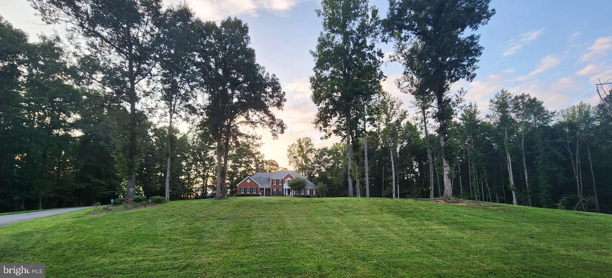 Welcome to the prestigious Chancellorsville Hunt Subdivision , where luxury meets sophistication. Nestled on 3.5 acres this extraordinary home offers an expansive living experience. Set on a beautifully manicured estate, this property boasts a grand approach with a long, private driveway flanked by stately trees and lush greenery. The front yard unfolds into an expansive, estate-quality lawn—rich, vibrant, and perfectly maintained—creating a dramatic sense of arrival and offering sweeping views of the meticulously landscaped grounds. The oversized master bedroom is a true oasis, providing a tranquil escape from the world. Each of the additional bedrooms also boasts its own full bath, providing ample space and privacy for family and guests. The finished basement with a walk-out provides additional living space, perfect for a home theater, gym, or game room. Enjoy the serenity of a secluded retreat while remaining just a short distance away from renowned amenities, shopping centers, and dining establishments.