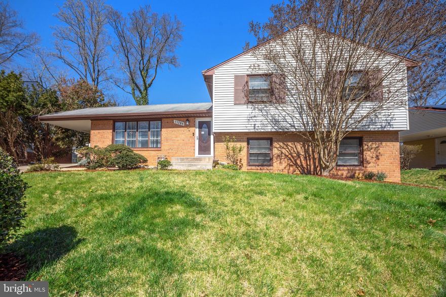 Welcome to this beautifully presented home with 2,875 sf of living space on 4 levels ready for new owners. Tasteful color schemes, gleaming hardwood floors and lots of entertaining space.  The main level features a gloriously large kitchen with stainless appliances, lots of granite counter space, rich ceiling-height cabinets, ceiling fan & recessed lighting, glass tile backsplash, breakfast bar area with elegant pendant lighting that spills into the separate dining area. The kitchen opens into the sunny living room with expansive views to the front from a big bay window.  The lower level family room has a central brick hearth gas fireplace great for gatherings and rear sliders to a lovely rear patio and yard for gardening, BBQ feasts, or quiet nighttime enjoyment under the stars. The second lower level features a media and game room large enough for a massive big screen TV, billiards table and arcade gaming. Upper level has an owner's ensuite with dressing area, 2 additional bedrooms with shared bath. Off-street parking with a concrete driveway to private carport with outdoor storage. Easy access to both Route 202 and Route 214 for ease of commuting. Lots of super shopping within a short drive. Prince George's Community College Educational Campus is nearby for adult learning, stellar arts & performances and home to the annual Bluebird Blues Festival. Enjoy all that Watkins Regional Park offers from live farm animals, a beloved carousel, picnic areas, gardening exhibitions and seasonal activities for all ages.  Public transportation routes and walking distance to local schools make this a great location. Don't miss making this one your next home!