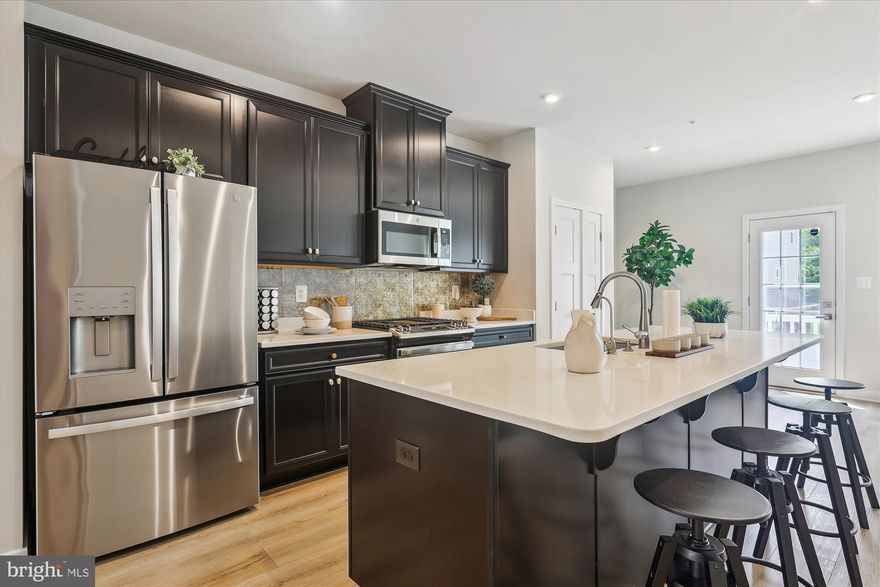 🏡 Elegant 2 Car Garage Townhome with upgrades galore in the Prestigious Westphalia Community!  Don't wait until  at least December for  new build a pay way more when you  can own this like new home now!  Upgraded appliances package,  Upgraded counter tops and flooring!  Most popular model when your guests enter on the main level instead of the lower level!!!

$$$ 1% LENDER PAID BUY DOWN  $$$   MAKES THIS AMAZING HOME EVEN MORE AFFORDABLE!! $$$$  

Welcome to refined living in this impeccably crafted Strauss Townhome, where style, sophistication, and comfort converge. From the moment you arrive, the front entrance ushers you directly into a luminous and inviting living space that sets the tone for effortless luxury.

✨ Main Level Elegance Enjoy the seamless flow of premium luxury vinyl plank flooring throughout the open-concept main level, marrying the aesthetic of natural hardwood with the durability needed for everyday living. The expansive living room transitions gracefully into the dining area and gourmet kitchen, creating an ideal setting for both lively gatherings and quiet evenings.

🍳 Chef’s Dream Kitchen At the heart of the home lies a show-stopping kitchen featuring an oversized island perfect for meal prep, casual dining, or socializing. Outfitted with state-of-the-art stainless steel appliances, upgraded Gorgeous Quarts counter tops—alongside an exquisite custom backsplash, this space is a culinary masterpiece.

🛏️ The upper level hosts three bedrooms designed for comfort and tranquility. The sun-drenched primary suite offers a peaceful retreat with ample space, a walk-in closet, and a spa-inspired ensuite bath showcasing upscale fixtures and finishes. Two additional bedrooms provide cozy sanctuaries for family or guests with access to a beautifully appointed full bath.

🛁 Thoughtful Design Throughout Both full bathrooms and two stylish half baths feature premium upgrades, ensuring functionality meets elegance at every turn. Convenience is elevated by smart design and attention to detail across every level of the home.

📍 Prime Location & Community Perks Nestled in the highly sought-after Westphalia community, this home offers access to world-class amenities including a state-of-the-art clubhouse, resort-style pool, and playgrounds. Ideally situated near major commuter routes, you’ll enjoy effortless access to Washington, D.C., Northern Virginia, Andrews Air Force Base, and premier shopping, dining, and entertainment destinations.

🚪 Move-In Ready & Impeccably Maintained This luxurious residence is truly turnkey—meticulously cared for and ready to welcome you home. Every detail has been thoughtfully curated to offer the ultimate in comfort and convenience.