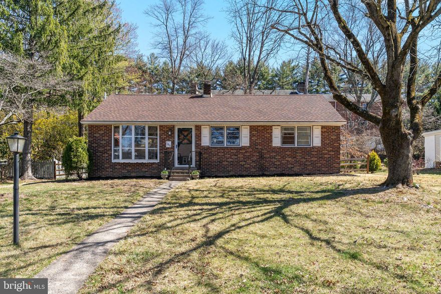 Adorable, affordable and in a perfect location with shopping, transportation and schools only minutes away. This charming brick ranch on a nice sized lot with a large backyard features wood floors throughout most of the first floor and has been freshly painted throughout.  A bright and open living room with an adjoining den for the perfect reading spot or office, a cozy dining room that is open to the living area and the kitchen and two bedrooms all await you. The full bath has been completely remodeled and offers a large vanity with drawer storage, plus two additional storage areas, tile flooring and a new bath/shower area with distinctive tile. All new hardware here plus in other areas of the home, updated lighting and lots of storage. Pull down stairs lead to the mostly floored attic for additional storage. The galley kitchen leads to the patio and large fenced yard. Tall trees behind the home offer a park like setting and privacy to enjoy your yard. A storage shed is included for garden tool storage. A separate counter area in the kitchen with cabinetry allows for extra work space and storage. Electric cooking, included refrigerator, double sinks and quaint knotty pine cabinetry make this a homey place to cook and gather. Steps to the finished basement room lead to the bar area with bilco doors to the fenced yard and an additional storage area which is large and used for laundry chores. The bar top and counters have been treated with a custom artisan finish and is the perfect spot for entertaining fun. The roof was replaced in 2023. Heater replaced in 2005, electrical updates in 2005 and a one year warranty is included for added peace of mind. There was an approval in place when the current owner purchased this home for the addition of a garage and driveway on the side of the home. Shopping centers and the center of town are an easy walk. The Memorial Day parade, Arts Fest and Doylestown Farmers Market are all just outside your door. No parking worries for the events in town!  Low taxes and utilities make this a best buy for location and efficiency. Be sure to see this one. This sweet home is ready for a new owner and quick settlement is possible.