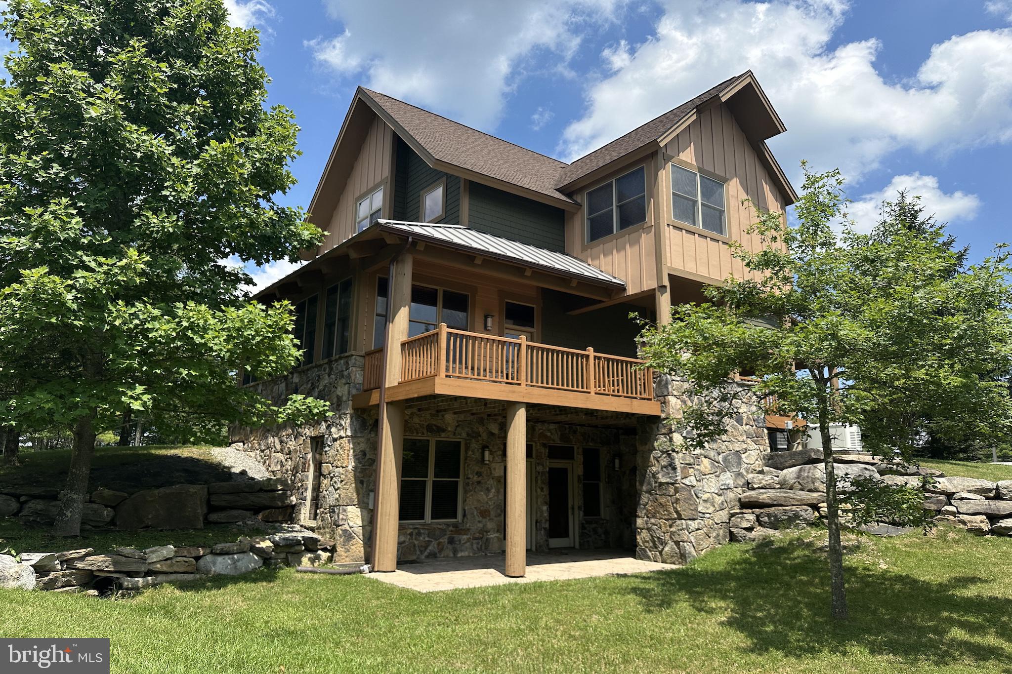 Discover mountain luxury in this beautifully maintained 3-bedroom, 3.5-bath Mountaintop Chalet near Wisp Resort with scenic Deep Creek Lake access. Exceptional craftsmanship and upscale finishes shine throughout its bright, open layout designed for entertaining. Gather in the cozy living room with stone fireplace, enjoy the comfort of a wonderful family room and versatile loft, and take advantage of the double carport. Custom blinds frame peaceful mountain views while keeping the home cool in summer. Recent enhancements feature a high-efficiency HVAC system along with fresh interior and exterior paint, creating a modern and inviting feel. This sought-after community offers exclusive lakefront access, peaceful walking trails, tennis/pickleball courts, playground, basketball, and an outdoor pool with pavilion—perfect for active days or quiet relaxation. Whether it’s winter skiing at Wisp, warm-weather lake adventures, or year-round outdoor fun, this ideal location puts you minutes from it all. A rare opportunity to own a high-quality home in one of Deep Creek’s most desirable destinations!