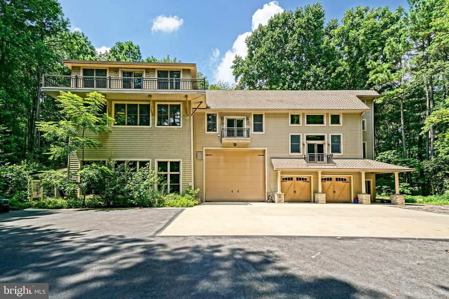 THE ULTIMATE COASTAL SANCTUARY! Experience this tranquil forest estate on this lovingly maintained 7.47-acre estate bordering the majestic Redden Forest. This one-of-a-kind architectural masterpiece offers a rare blend of total privacy and prime location, creating a park-like atmosphere that remains a cool summer oasis and a sun-drenched winter retreat. The expansive 8,057-square-foot custom-built main residence defines grand-scale living across four meticulously planned levels, all easily accessible via a private residential elevator. At the heart of the home, a breathtaking two-story great room features walls of glass that frame panoramic forest views and fill the open-concept floor plan with dappled sunlight. The chef’s kitchen is a model of functional elegance, boasting soft-close cabinetry and abundant storage, while a signature spiral staircase leads to a third-floor study nestled high within the tree canopy for the ultimate peaceful escape.

Luxury amenities abound, including a spectacular indoor spa wing with vaulted ceilings - maintained by a premium Desert Aire climate system - and an adjoining greenhouse for the botanical enthusiast. Outdoor living is equally refined, featuring a stone path that leads to a custom fire pit with circular stone seating, perfect for starlit gatherings. For the hobbyist or traveler, the oversized three-vehicle garage includes a specialized bay with a 20-foot door to accommodate a large RV or boat. Adding to the estate's versatility is a charming 532-square-foot detached guest cottage, complete with a kitchenette, full bath, and sunroom; ideal for a studio, home office, or extended family. Perfectly positioned just 30 minutes from the Rehoboth Beach boardwalk and Cape Henlopen State Park, this estate offers the best of both worlds: nature’s tranquility and vibrant coastal convenience. Bring your vision to this incredible property and create your personal legacy retreat. Schedule your private tour today!