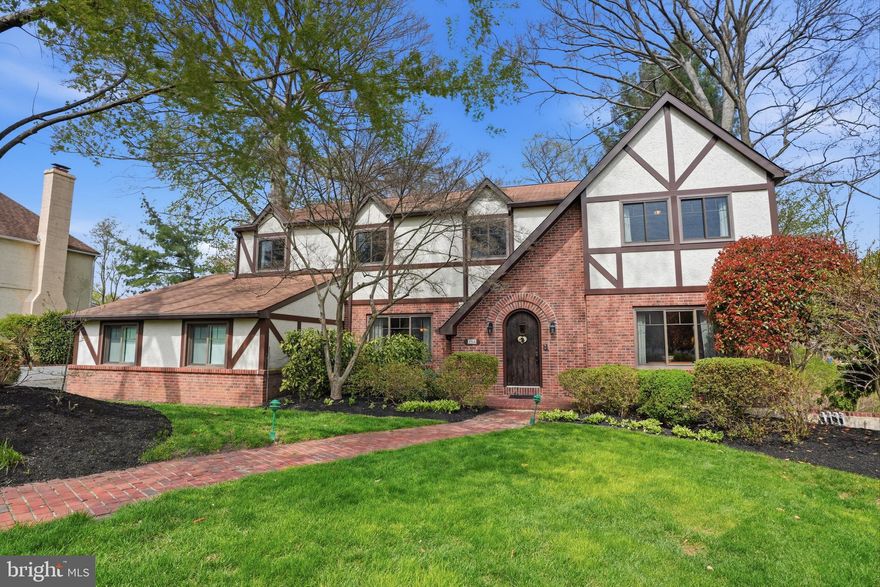 Welcome to Biddle Estates — a sought-after neighborhood known for beautiful homes, large lots, and homeowners who rarely leave. Set on a scenic lot, this home offers a quiet retreat that’s hard to find. This handsome Tudor-style home welcomes you through an arched wood door into a traditional colonial layout, beginning with a dramatic two-story foyer, a formal living room and a generously sized dining room ready for gatherings of any kind.

The updated kitchen is thoughtfully laid out, with an island, pantry, under-cabinet lighting, gas range, built-in microwave/convection oven and an eating area that naturally becomes the center of the home. It opens to the inviting family room, creating a connected space for daily living and entertaining, anchored by a wood-burning brick fireplace.  Both the kitchen and family room have bay windows, offering stunning views of one of this property's standout features --a sprawling backyard with woods beyond. Step outside onto the expansive deck (rebuilt in 2020) and enjoy everything from quiet evenings listening to nature, to summer cookouts with friends.  A laundry room and powder room complete the first floor.

Upstairs, you’ll find four well-sized bedrooms and a hall bath. The expansive primary suite includes a sitting area, walk-in closet, and an updated bathroom with a tub and separate shower.

The finished basement offers flexible space for a gym, rec room, or workspace, with its own exterior entrance — a great bonus for whatever you need it to be.

The side-entry three-car garage gives you more space than you thought you needed, and recent updates like newer front windows add peace of mind.

The location ties it all together — with Pennypack Trail and Lorimer Park nearby, and regional rail just a mile away for quick access to Center City.