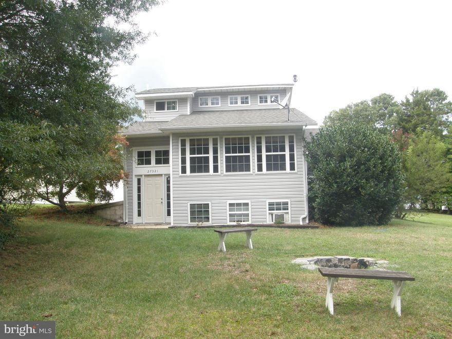 Centrally located this radiant contemporary home is turn key ready!!!! Many improvements to this home include recent landscaping, New architectural shingled roof in approx 2018, new siding approx 2019 and kitchen was modernized in recent years including corian counters with breakfast bar and recessed lighting. Living room has high ceilings and features a gas fireplace to enjoy on a winter night. There are 2 Bedrooms and 2 full bathrooms plus a bedroom/hobby room in basement plus a family room. Enjoy entertaining on the expansive deck with vinyl railings. Don't forget the hot tub for relaxation!!!! Large shed for storage and  there is a seasonal view of the Patuxent River.  If you are hungry walk down to Sandgates or Sea Breeze for a meal or drink. Do not delay on this rare find- a great home at a great price and best of all the location!