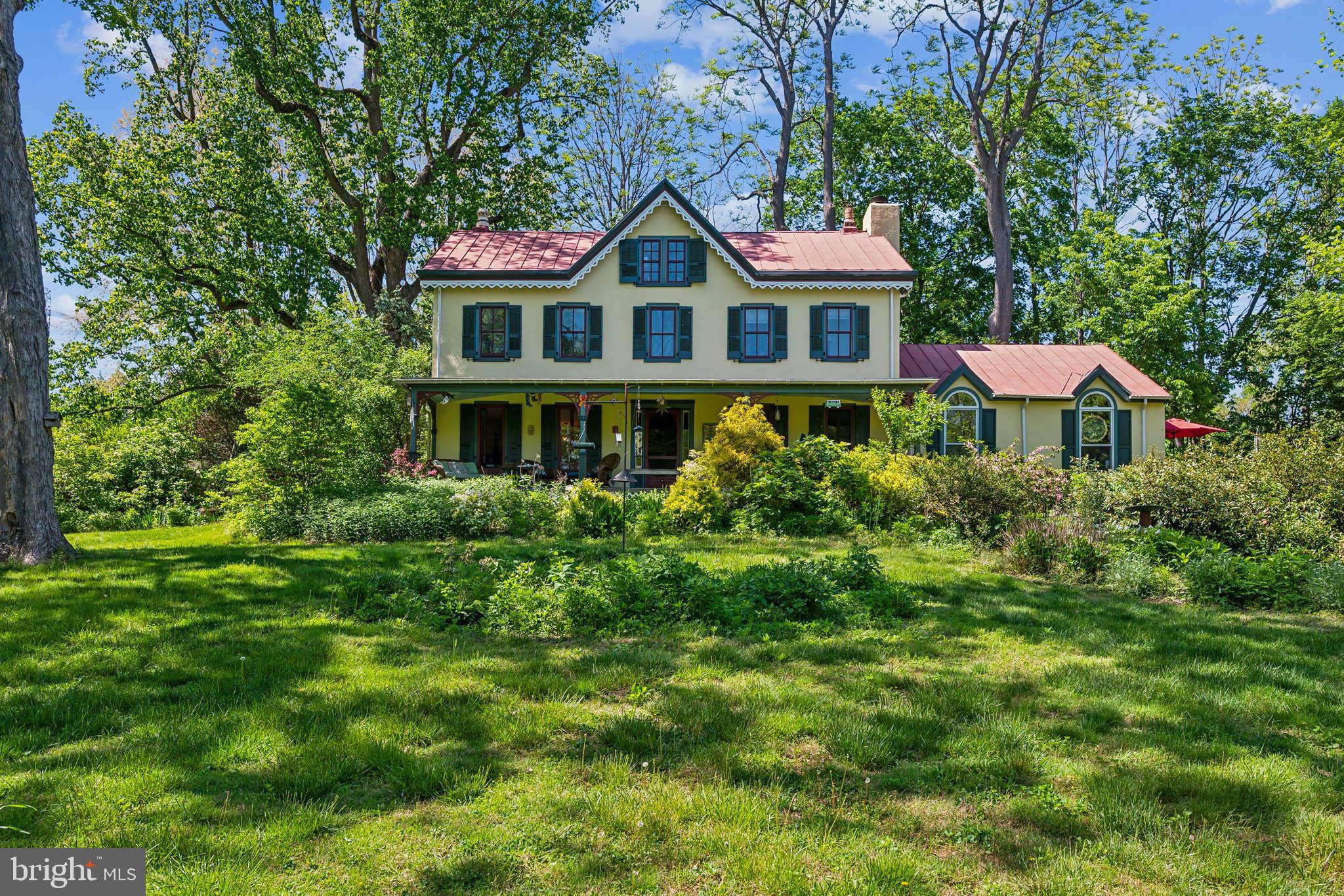 Located just minutes from the Turnpike and Blue Route, this private enclave offers exclusive verdant landscape views and fully updated modern amenities. Circa 1840 stucco over Stone Victorian Manor House set on 2.3 tranquil acres including 907 Florence Lane. Expansive Southern-facing porch featuring restored gingerbread details. Deep-set window sills, random width, old-growth hardwood flooring, and wonderfully preserved period millwork throughout. The modern kitchen addition features an artfully exposed stone wall, an exposed-beam vaulted ceiling with skylights, and Cherry WoodMode custom cabinetry featuring granite counters, a center island, a Breakfast nook, and abundant storage. Just off the amazing kitchen is a flagstone patio perfect for outdoor dining or relaxing while admiring the beautiful landscape featuring specimen plantings, mature trees, and spectacular wildlife. The living room features a wood-burning fireplace and fabulous built-ins. The dining room features a double-sided gas fireplace, perfect for hosting your next dinner party or Thanksgiving feast. The spectacular family room with vaulted, beamed ceiling shares the double-sided fireplace with the dining room and has Palladium windows & doors to a mahogany deck. This house BEGS to entertain! Superbowl party, anyone? The updated main bedroom has an ensuite marble floor bathroom with a double vanity, claw-foot tub, and an oversized frameless glass stall shower. Two additional bedrooms on the second floor have a shared hall bath featuring a whirlpool tub and shower. Period correct high efficiency wood core custom windows let in the light and keep in the heat or A/C. The third floor boasts a shed dormer addition completed in 2005 by renowned historic contractors Hanson Fine Building and Restoration. Offering two large bedrooms with custom reproduction millwork period correct to complement the original details, energy efficient windows yielding abundant natural light, and a shared full bath with frameless glass stall shower. Improvements and renovations on this home were made with exceptional care and attention to detail rather than cost. Retaining the original charm and blending modern materials and innovations, such as the 6-zone Buderus hot water natural gas condensing boiler feeding radiant floor and baseboard radiators. Also, three-zone central A/C and a Generac 22 kW natural gas generator. Don’t miss the large heated inground pool!