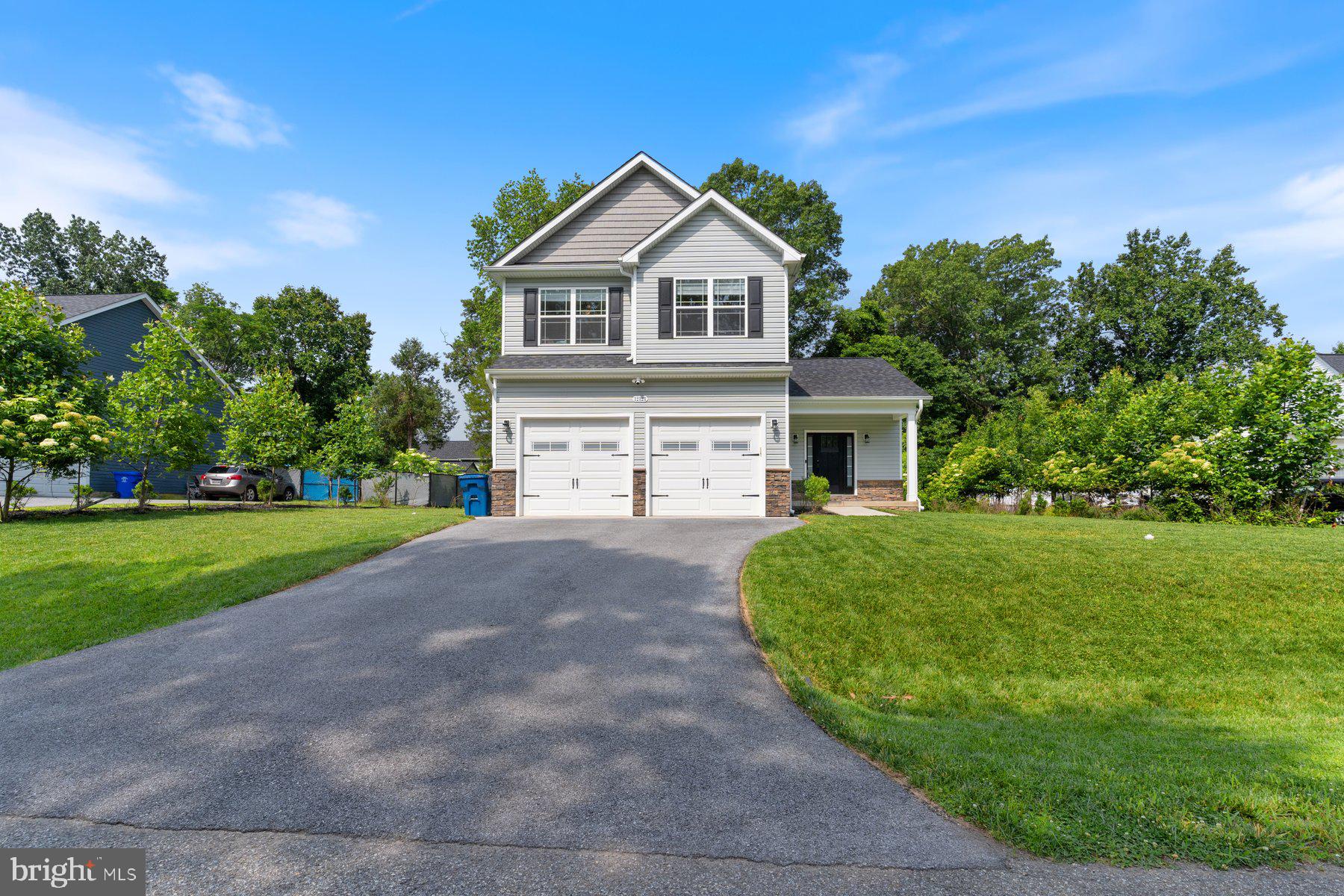 Move-in ready 3BR/2.5BA Colonial situated on a sprawling lot in Clifton on the Potomac. Park just steps from the covered front entry into your forever home. Step inside a home filled with tons of natural light, an open concept floor plan, crown moldings, a soft color palette, and beautiful flooring. The main floor offers a large living room, spacious dining room with a banquet of cabinets, a half bath, and a spectacular kitchen. The kitchen features plenty of cabinets including a pantry finished to the ceiling with crown moldings, stainless steel appliances including a slide-in electric range, sleek quartz countertops, a beautifully tiled backsplash, a deep sink under a window, a spacious island with pendant lights and breakfast seating for three or more, and a chalk painted wall. On the second floor are two sizable secondary bedrooms, a full bath with a double sink vanity, the convenience of second floor laundry, and a large primary suite. The primary boasts a tray ceiling, a large walk-in closet, and a private bath featuring a double sink vanity, and a beautifully tiled walk-in shower. The lower level is semi-finished, with a walk-out, offering you the opportunity to create the spaces needed to accommodate your families needs. From the main floor access the two-car garage, or step outside to a yard filled with green space, shade trees, and tons of possibilities. This home is ideal for any new homeowner and is located in close proximity to shopping, restaurants, and commuter routes.