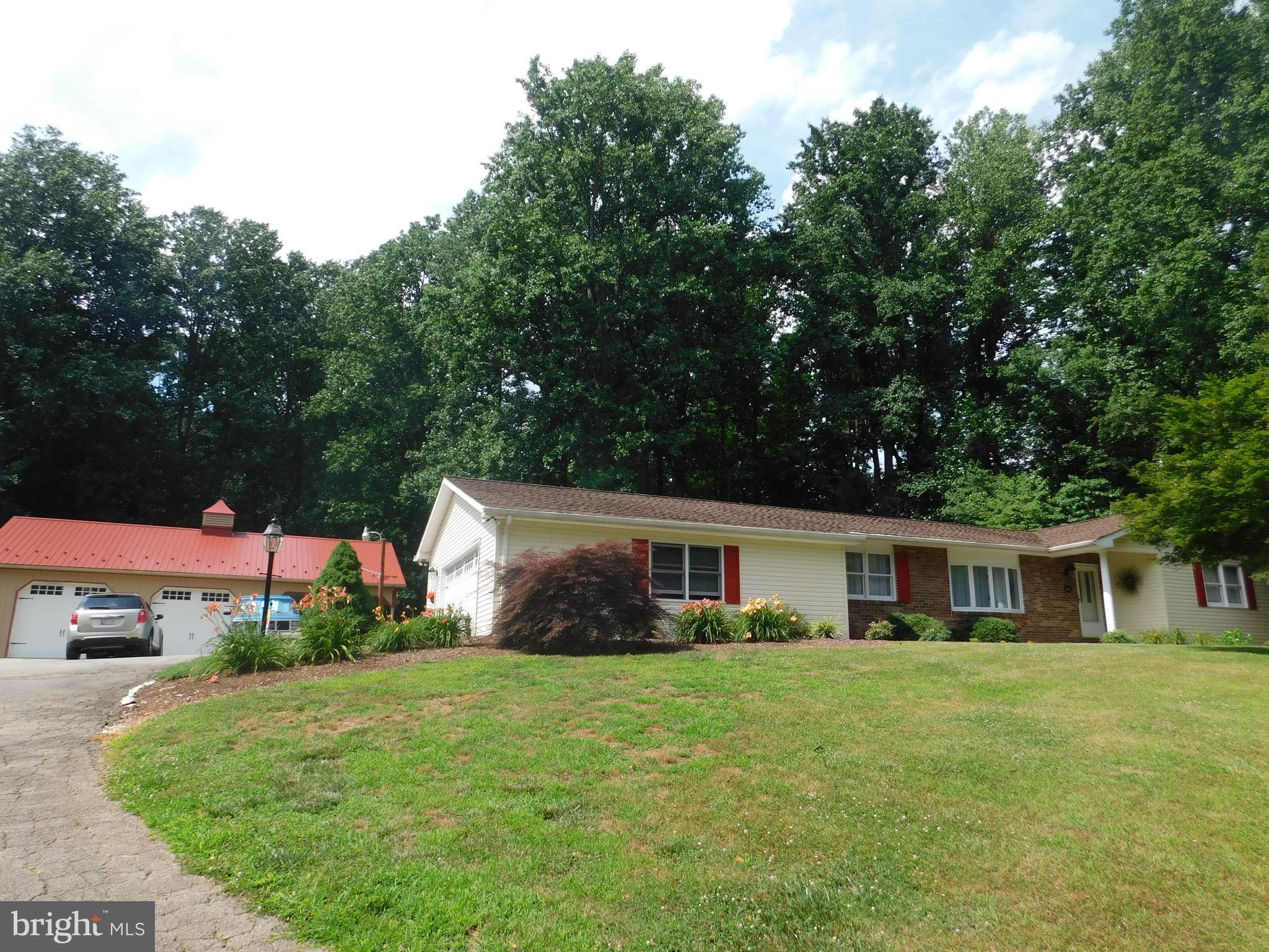 Beautifully maintained, immaculate rancher on almost 3 acres! Hardwood floors on main level, updated kitchen, updated baths, new carpet in huge finished basement with wood stove and super sized pole building with extra tall doors and attached pavilion in a park like setting are just some of the wonderful features of this home! USDA approved financing area. Come see! It's a 10!