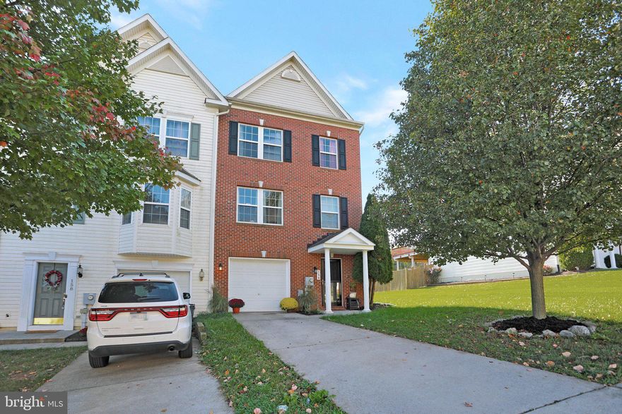 Spacious 3-level, brick fronted,  end unit townhouse enhanced with bump-out on all levels!  Private driveway with attached garage.  Beautiful mature tree in front offers shade and privacty.  Nice level yard backs to trees .  Walk-in  level features a spacious foyer, inside access to garage,  large family room with roughed-in bath, and sliding doors opening  to the back yard.   The main level offers a generous living room, half bath,  large  open, light filled kitchen featuring ample dining area, island, pantry and sunroom/bonus room with sliding doors. Just add your deck and you have easy access to outdoors from main level to cook out, entertain or just sit and relax.   Upper  level features a large owners suite and  walk-in closet, sitting area, and vaulted ceiling. The pivate bath offers dual vanities,  soaking tub and separate shower,  Two  additional bedrooms, a full hall bath, and laundry.   Convenient commuter location within minutes of commuter rail and I81. Close by shopping, medical facilities, and restaurants. Call for your appointment today!