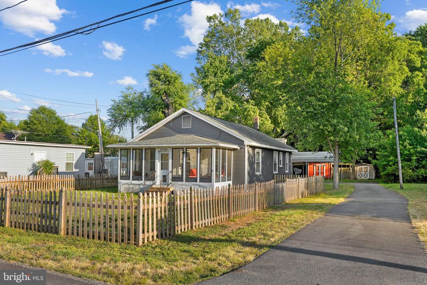 Nestled in the heart of King George, right next to the Dalghren Naval Base, this delightful ranch-style home offers a serene retreat on a generous 0.46-acre lot. Surrounded by lush trees, a fully enclosed sunroom, and a charming picket fence around the front yard. This property provides a peaceful backdrop, perfect for relaxation and outdoor activities. The corner lot features both a front and rear yard, ideal for gardening or enjoying sunny afternoons. With a detached garage, a 2-vehicle carport, and 2 large sheds, you have plenty of storage for recreational fun on wheels or lavish items. Conveniently located, this home is just a short drive from local parks, where you can enjoy walking trails and recreational facilities. The community is known for its friendly atmosphere and vibrant spirit, making it a wonderful place to connect with neighbors. Nearby schools are well-regarded, providing excellent educational opportunities. With ample parking options, including a detached garage and carport, this property is designed for convenience. Embrace the comfort of home in a community that values connection and nature, where every day feels like a getaway.