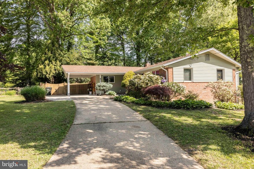 Serene privacy! This home is set back off the street in a quiet lovely neighborhood. The back yard is wrapped in trees offering the ultimate in privacy in a natural setting. The front yard is full of mature flowering plantings, bushes and trees and is beautifully landscaped. The designer front door opens to a large living and dining room area with hardwood floors with a designer inlay making it a unique and open space. Lots of natural light gives the home a sunny vibe. The kitchen has beautiful tile flooring laid out in a unique pattern and complimenting the designer cabinets. There is plenty of storage in the spacious kitchen along with working counter space. A coffee bar and a breakfast bar make this a kitchen a cooks dream. Walking down the hallway leads you to three spacious bedrooms and a beautifully decorated full bathroom. The large primary bedroom has its own bathroom with a  tiled walk in shower. The entire house was freshly painted in April 2025 in light inviting colors that accent the flooring and the overall look of the home. The basement has a large recreational room currently being used as a workout room but is just waiting for your personal touches. There is luxury vinyl hardwood flooring in the basement for easy clean up. There is a half bath in the basement as well as a work room, laundry area and storage. The basement has a walkout door to the side yard. Located in the Kings Park community it is close to shops and restaurants. This is a beautiful home just waiting for your personal touches. Don't miss this one.