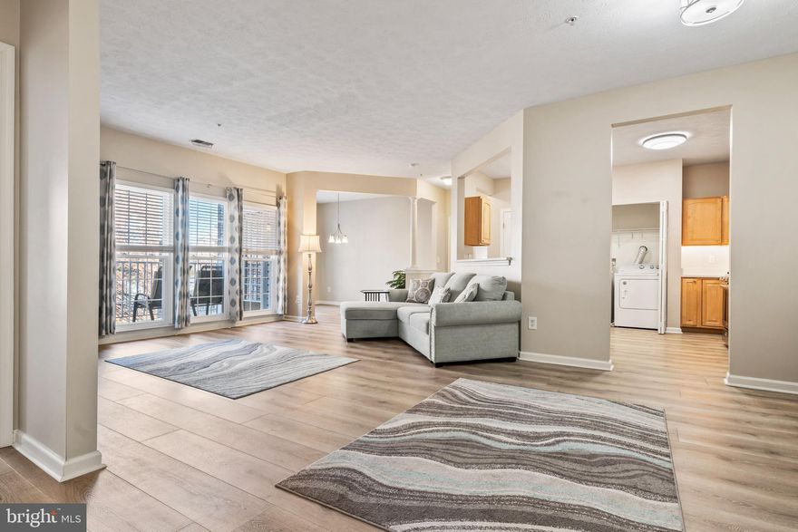 Welcome home to this well-maintained second-floor condo offering over 1,300 square feet of finished living space in the highly desirable, secure Devonshire community, complete with elevator access. This brick-front, garden-style residence features 2 spacious bedrooms, 2 full baths, and a versatile bonus den, all designed for comfortable, low-maintenance living. From the moment you enter, you’ll appreciate the open-concept layout and beautiful luxury vinyl plank flooring that is both water- and scratch-resistant. A large storage closet and separate coat closet flank the entry, providing excellent everyday functionality.

The fully updated kitchen is thoughtfully designed and equipped with stainless steel appliances including a gas range, quartz countertops installed in 2021, and rich maple cabinetry featuring pull-outs, a lazy Susan corner cabinet and under cabinet lighting. A large pantry and a full-size washer and dryer are conveniently located within the kitchen area, making daily living effortless. The bright and inviting living area is filled with natural light and flows seamlessly into a bonus den that works perfectly as a dining space, home office, or flex area. Step outside to the private balcony, complete with a sliding screen, overlooking a peaceful common area. The balcony was upgraded with new composite decking in 2023 and also features a custom roll-down shade and a utility closet for additional storage.

The spacious primary bedroom offers newer carpet installed in 2022, newer blinds from 2023, and two closets, including a walk-in closet and a second mirrored closet. The primary bathroom features double sinks, a large vanity mirror, a generous linen closet, and a walk-in shower with built-in seating and safety grab bars. On the opposite side of the unit, the second bedroom also features newer carpet and has direct access to the second full bath, which includes a linen closet and a tub/shower combination.

Additional updates and highlights include all new double-hung windows installed in 2021, HVAC replaced in 2019, new smoke detectors in 2021, newer light fixtures, new blinds throughout, and all appliances replaced in 2018. The condo includes one assigned parking space with ample guest parking available. Monthly condo dues of $340 cover water, sewer, trash, snow removal, common grounds maintenance, management, reserve funds, and exterior building maintenance. Ideally located just minutes from shopping, dining, and medical facilities, with easy access to I-695 and I-95, this home offers true maintenance-free living in a beautiful community. Condos in Devonshire are in high demand, so don’t miss your opportunity—check out the 3D virtual tour and schedule your exclusive showing today.