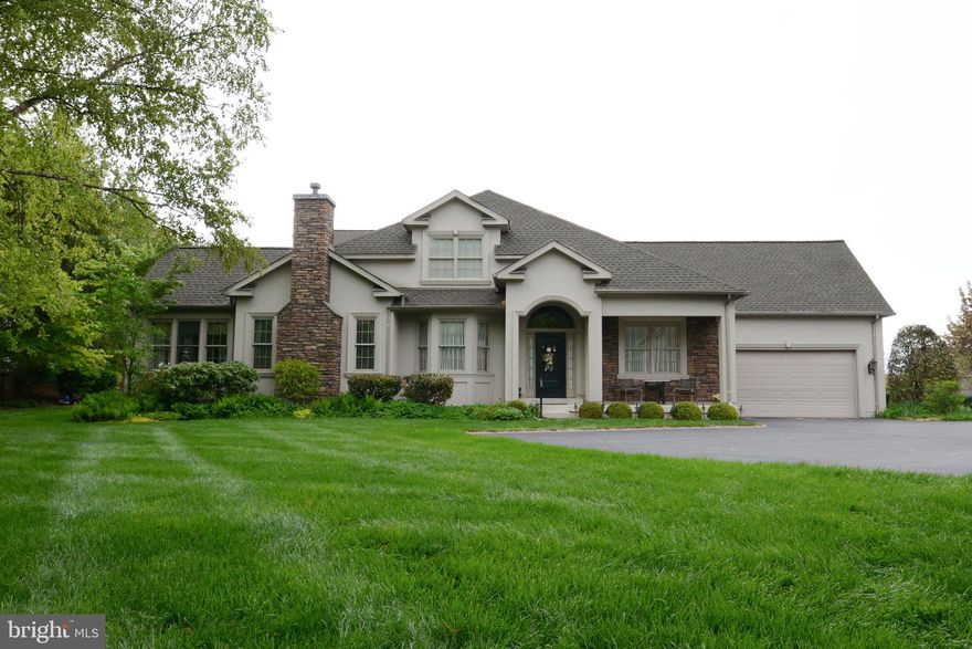 Welcome to 271 Country Club Drive, a beautifully appointed end-unit carriage home in the highly sought-after 55+ community of Indian Valley Greenes. Showcasing refined craftsmanship and upscale finishes throughout, this residence offers the perfect blend of elegance, comfort, and space.  A grand two-story foyer, illuminated by a Baldwin brass chandelier, sets the tone with rich cherry hardwood floors and extensive custom millwork. The formal living and dining rooms are bright and sophisticated, highlighted by bay windows and detailed architectural ceilings.  The gourmet kitchen is designed to impress, featuring an oversized island, granite countertops, Decora cherry cabinetry with smart storage solutions, a glass tile backsplash, and a walk-in pantry. It opens seamlessly to the inviting family room with a gas fireplace and casual dining area. French pocket doors lead to a sun-drenched sunroom with cathedral ceilings and access to a private, extended deck.  The spacious first-floor primary suite offers a tray ceiling, two walk-in closets, and a luxurious en-suite bath with marble flooring, a large tiled shower with rain head and body sprays, a jetted soaking tub, and a double vanity. A powder room with elegant finishes, a laundry room, and direct access to the two-car garage complete the main level.  Upstairs, you’ll find two generously sized bedrooms, a full bath, a charming library with built-ins, and a versatile loft/studio space with French doors—ideal for a home office or hobby room.  The finished basement adds approximately 1,100 square feet of exceptional living and entertaining space, complete with luxury vinyl plank flooring, a full secondary kitchen with island and double wall ovens, a serving area, and a private den featuring a wine cellar and a specialized, ventilated cigar room. A full bath, storage areas, workshops, and Bilco stairs provide added functionality.  Additional highlights include fully remediated stucco, a hardwired security system, 75-gallon water heater, and a new GAF roof (2025) with a 50-year transferable warranty.  Located adjacent to Indian Valley Country Club, this home offers access to one of the area’s premier private golf clubs, known for its pristine course and elegant amenities.  This exceptional home delivers luxury living at its finest—schedule your private showing today.