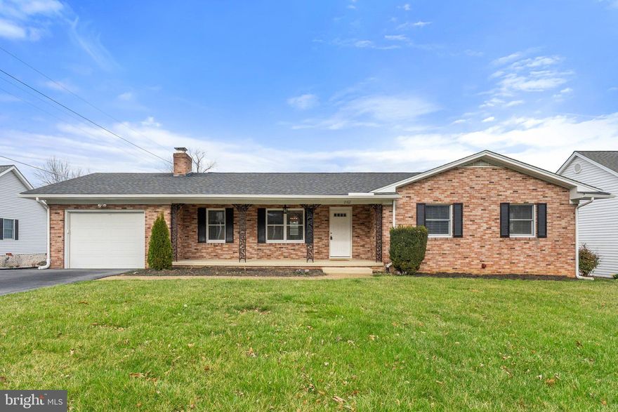 This beautiful, multi-color brick rancher is in immaculate condition with so many inviting features. You’ll love the sitting porch, where you can enjoy a quiet moment or say hello to a passing neighbor. Inside, neutrals and pristine hardwood floors augment an eye- pleasing floor plan. The living room gets lots of natural light, is warmed by a fireplace, and its rectangular shape lends itself to easy furniture arrangement. The dining area is roomy enough to expand seating and have additional display or buffet pieces, and sits adjacent to the expansive kitchen, where you’ll find room to prep, cook, and create on those quartz counters. There’s plenty of cabinet storage and a geometric flair between the slatted wood fronts and backsplash design. The primary bedroom suite is a perfect size with an attractive attached bath. Soak in the tub or use as a shower. There are two additional bedrooms and another full bath. And the laundry room is worth a mention, giving you top-of-the-line appliances along with a bank of cabinets, utility sink, and folding area. But this rancher also includes a massive downstairs with a handsomely bricked wall and woodstove, a bar with seating, built-in shelves, and space for leisure and entertainment. There’s a fourth bedroom and half-bath plus separate storage areas. Exit to the backyard here or from the main level and enjoy a lush backyard, deck, and big shed outfitted with electric and a garage door. This could be used so many ways, such as an art studio, garden center, or woodshop. The home also contains a one-car garage with space for a lot more than a vehicle, and the A/C and water heater were recently replaced. You can tell by one look how loved this home has been, and with 1,502 square feet on each level, it provides an astounding amount of space, with great features and location.