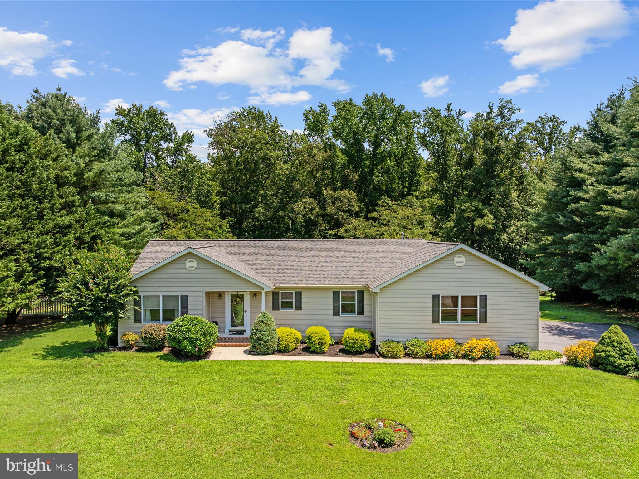 Welcome to one-level living at its finest on the Eastern Shore! Featuring an open-concept floor plan, this home is flooded with natural light, making it perfect for both relaxation and entertaining. Step inside to discover a spacious living area with vaulted ceilings centered around a cozy gas fireplace, ideal for chilly evenings. The kitchen has been updated with granite counters, stainless steel appliances, and provides ample space for a chef to cook & create! The primary bedroom is a true retreat of its own, complete with a spa-like ensuite bath that offers a touch of luxury to your everyday routine. The other bedrooms are equally spacious, providing comfort and privacy for family or guests. An expansive finished sunroom, equipped with heat & AC, offers a versatile space to enjoy year-round. Situated on a large, flat lot, this property backs to lush woods, providing peace and serenity while you enjoy your outdoor composite deck space with retractable awning that overlooks the pool area. An oversized two-car garage with additional storage and an expanded driveway offer ample parking and convenience. Located in a quiet neighborhood with wide streets, this home offers ease of living with tons of ways to entertain friends and family. Recent upgrades include: Roof 2023, HVAC 2022, water heater 2022, well pump 2019, Pool filter motor 2023, Fridge 2023, fresh paint, luxury vinyl plank flooring, and more! Welcome Home!