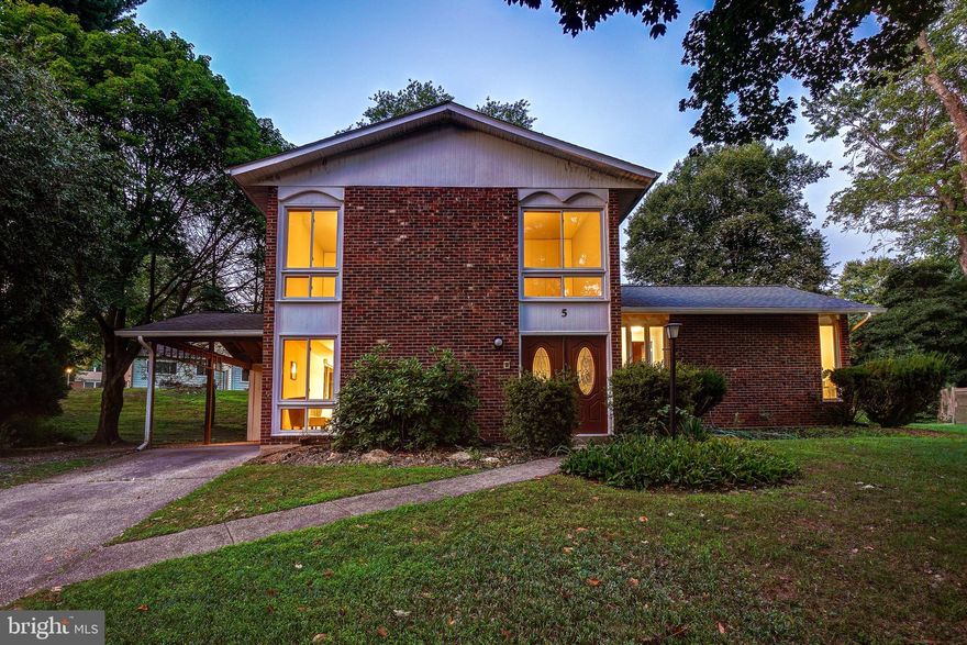 Welcome to 5 Autumn Court! This freshly painted, stately colonial, built in 1969, is ideally situated on a quiet, tree-lined cul-de-sac in the Woodlawn Terrace neighborhood of Silver Spring. Featuring recessed lighting, replacement windows, luxury vinyl flooring, and wonderful architectural details, this spacious home offers modern comforts and timeless charm.

Enter through double doors with etched glass accents into the inviting foyer. Beyond the foyer, you'll find a reconfigured family room / breakfast room and kitchen that open to one other. The kitchen offers beautiful Silestone counters, an island, a ceramic tile backsplash, a pull-out pantry, and access to the carport. The large living room features a brick fireplace, new luxury vinyl flooring, and French doors leading to the backyard. The main level is complete with a powder room and a large coat closet. Just a few steps up is a light-filled dining room with recessed lighting and vinyl plank flooring.

The second level features four well-proportioned bedrooms and two newly renovated full bathrooms, including a primary bedroom suite. The generous primary suite boasts new carpeting, three closets, a dressing area with a vanity, and a private full bathroom.

Downstairs, you'll find a fabulous recreation room with a wet bar and storage space. The home is situated on a cul-de-sac with minimal traffic and boasts mature landscaping on a large level lot (13,213 square feet). The property also includes a convenient carport and driveway.

You can't beat this location – ideally situated near the Intercounty Connector, Paint Branch Park, and Martin Luther King Jr. Recreational Park. This home offers everything you need for practical living and easy commuting, just 30 minutes from both Washington, DC, and Baltimore. Plus, it's just minutes away from shopping and restaurants!