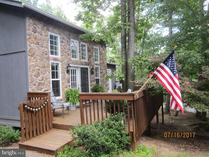 This 2521 sq ft 14 yr old 3br/2ba contemporary home on .33acres has level parking and no step entry from an extra lg deck and a beautiful stone front exterior. The interior has a bright open lr/dr/ki with a featured floor to ceiling  stone propane fireplace. The excellent 1st floor master completes the main floor living. Lovely lower level family room has french doors to a very private patio.