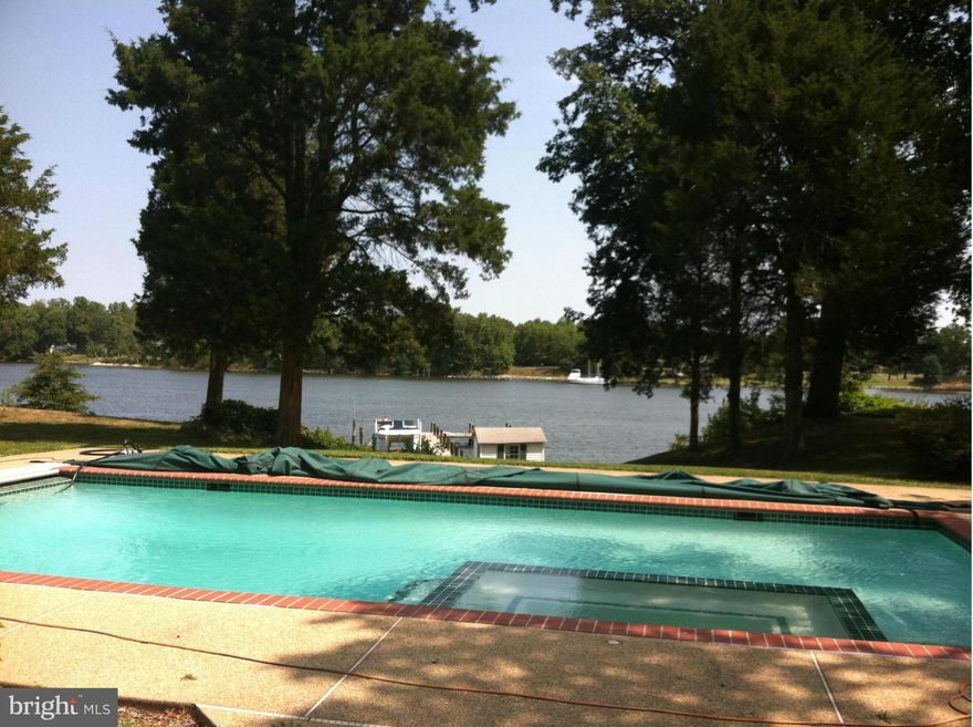 BEAUTIFUL WATERFRONT HOME Perfect for entertaining, secluded including. Private Pool w Hot Tub & elec.pool cover. Easy walk down gentle swale to your 100 ft. pier & convenience of a 10K lb boat lift, with water & elec. Bring any size boat you have. This pier plenty of length, pilings (MLW) over 8 ft. One & half car garage w work shop, pool house and pier shed. CLOSE TO SOLMNS ISLAND