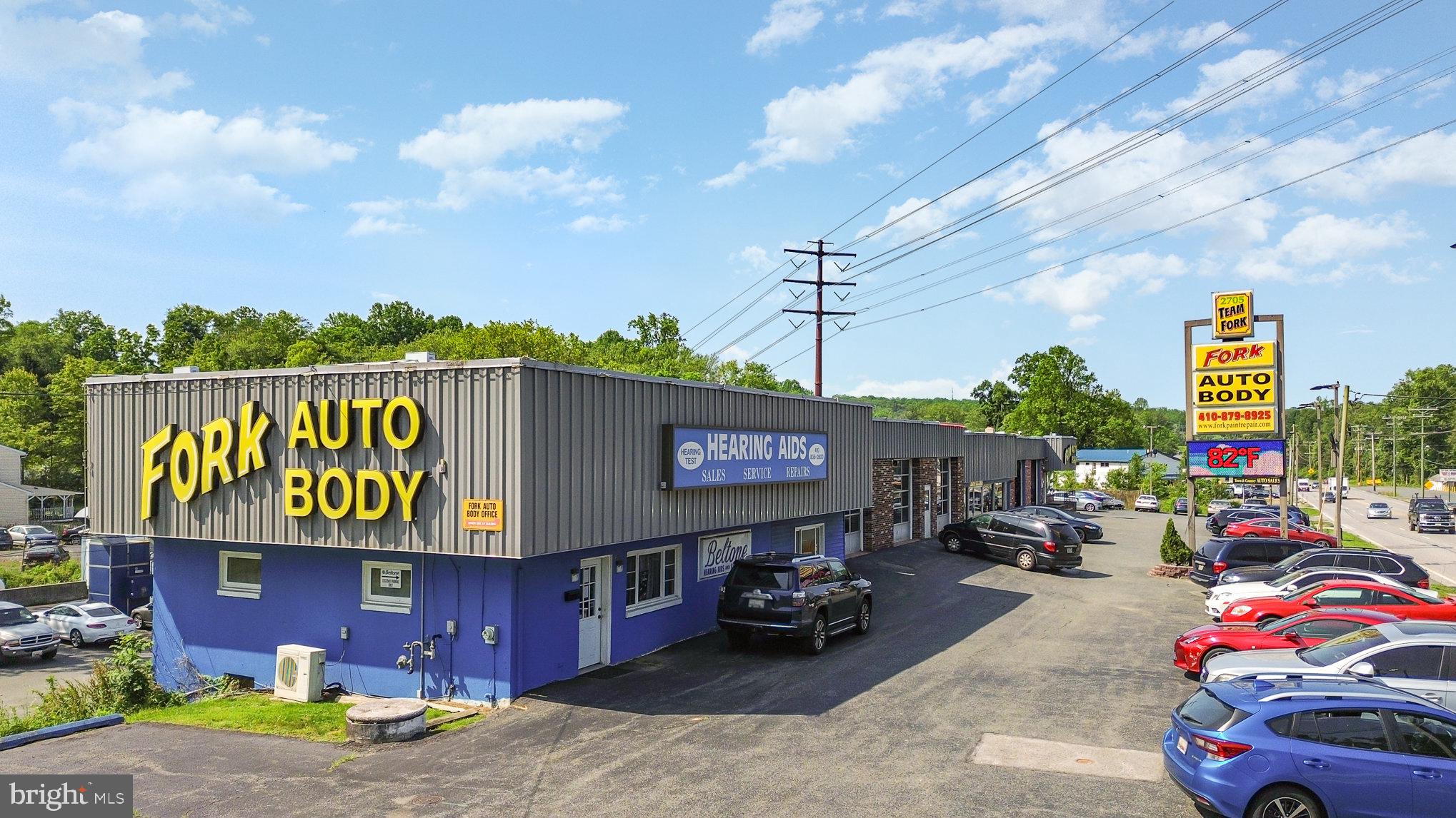 Auto Service building for sale or lease in Fallston MD. Fork Auto Body has owned and operated their business from this location since 1960. The 2 all-brick/block construction buildings have a combined 22,000SF on a 2.27 acre lot. The front building has 19 service bays + office and showroom space. The rear building is a legal paint booth with 4 service bays. There is parking in front, in between buildings, with additional outdoor storage in the rear. There is additional space for expansion of the property to the West under the BGE easement area as has already been utilized by the current ownership. There are 20,000 cars per day on Bel Air Rd passing the site daily. There are currently 2 active Tenants on site besides Fork Auto Body. Beltone Hearing Aids leases the front Blue building for $1200/month on a monthly lease. A towing company leases a small gated section in the far Southwestern section of the property for $700/month on a yearly basis. This property would be a great fit for any end-user looking to break into the Fallston/Harford County market.