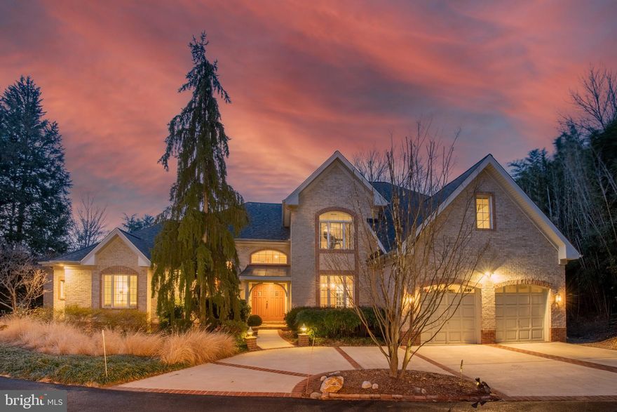 One of Bethesda’s only true water-view offerings, this extraordinary one-owner custom residence by renowned Rembrandt Builders is a rare and remarkable find. Expertly crafted in solid brick, this exceptional home is set against a serene, expansive private pond - creating a resort-like setting unlike anything else in the area. Featuring over 3,685 sq. ft. of luxurious living space with 5 bedrooms and 3.5 bathrooms on an over half-acre lot with gorgeous views, this home has it all - with one of the bedrooms acting as the main level primary. A private driveway leads to striking masonry, a circular drive with additional gravel parking, and an oversized two-car attached garage - offering both privacy and abundant convenience. Step inside to discover rich hardwood floors throughout, complemented by recessed lighting, tiered crown molding, oversized baseboards, and walls of windows designed to capture breathtaking pond views from nearly every room. The dramatic main foyer opens to a double-height cathedral-ceiling living room with French doors leading to the rear deck, creating a seamless indoor-outdoor living experience. The main-level primary suite is a private retreat, featuring tray ceilings, a study, French doors overlooking the water, and a spa-inspired en-suite bath with a Jacuzzi tub and a separate walk-in shower with built-in tiled bench. At the heart of the home lies a gourmet, top-of-the-line chef’s kitchen with an oversized island, stainless steel appliances, designer pendant lighting, and upgraded backsplash. The kitchen flows effortlessly into both the eat-in area and the family room, where custom-built-in cabinetry frames a stunning stone-tile fireplace. Another set of doors opens to the covered rear patio—perfect for entertaining or quiet evenings by the pond. The main level is completed by a formal dining room, laundry room, and interior access to the garage - thoughtfully designed for everyday ease and functionality. Upstairs, you’ll find four generously sized bedrooms and two full baths. One bedroom offers additional bonus storage, while another features reinforced flooring - ideal for a home gym or flexible living space. Outside, the wraparound rear porch features both a covered brick patio and an open deck, all overlooking one of the most spectacular natural backdrops Bethesda has to offer. With panoramic water views and unmatched tranquility, this property offers a truly one-of-a-kind lifestyle. Plus, New Roof (2025), House Generator, Gutters Cover, Garage Tek Storage System, Water Filtration System for Kitchen Faucet, and more.