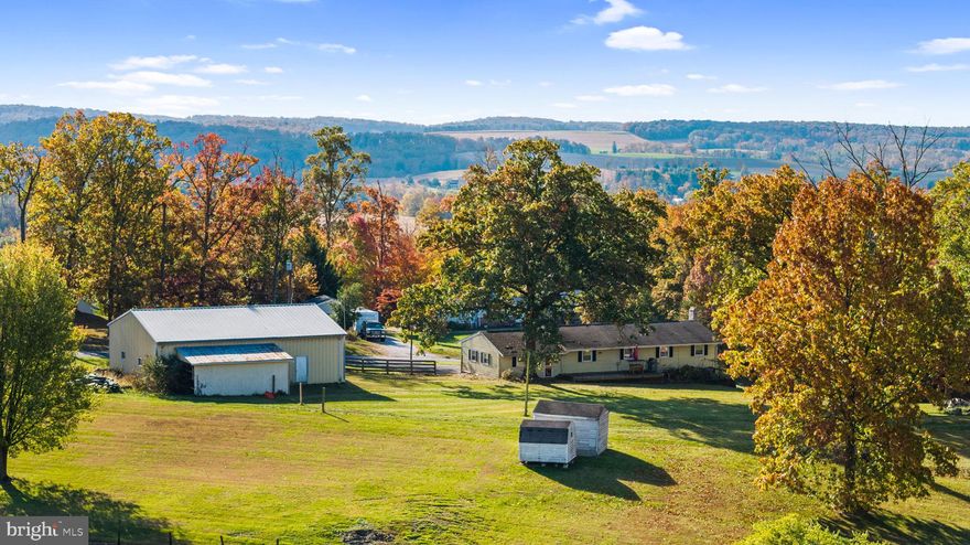 Opportunity is calling! Wonderful 3 bedroom, 2 full bathroom rancher home on 3.17 acres, plus an additional 2.18 acre separately deeded lot with its own well. Large open kitchen with oversized family room. Nice hardwood floors throughout home. Recently renovated full bathroom on the main level plus newly added full bathroom on lower level. New septic system. Recently added recessed lighting. Huge detached two story garage with car lift- perfect for storing landscape equipment, a car enthusiast, or the workshop of your dreams. Multiple porches and places to enjoy the outdoors including: covered front porch, back porch for grilling and enjoying the views, side patio with brick outdoor fireplace. A peaceful country retreat to call your own!