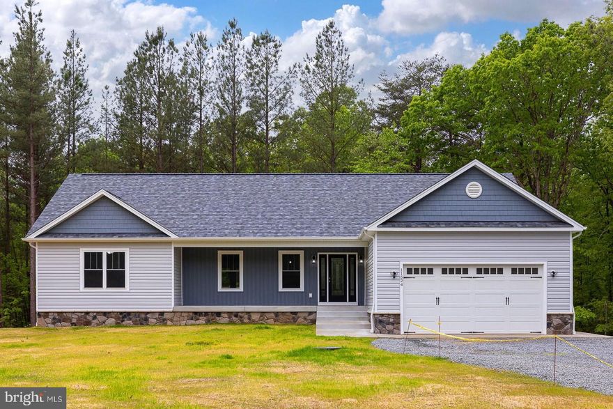 Indulge in the stunning pond and wooded views from this breathtaking one-level home, perfectly tucked away on a serene 4.5-acre homesite in the gorgeous Estates at Light Lane.  Prepare to be amazed by the spaciousness of this three-bedroom, three-bath open floor plan, offering tons of upgrades and endless possibilities for comfortable living and entertaining. The living room features a cozy fireplace with a stone surround that adds warmth and charm to the space. Whether you're enjoying a quiet evening or hosting friends and family, this room will become the heart of your home. The kitchen awaits the aspiring cook or entertainer in you. The stunning design boasts soft-close cabinets, a large island with a vegetable sink and wine rack, a farmhouse sink, stainless steel appliances, a tile backsplash, and exquisite granite countertops. After a long day retreat to the tranquility of the primary suite, complete with his and her closets, including a custom walk-in closet, a charming barn door that leads to the luxurious bath, adorned with beautiful custom tile work and a soaking tub perfect for unwinding and pampering yourself. Discover the full potential of the walkout basement, offering endless possibilities for customization and expansion. With a full finished bath, this space provides ample room for recreation, additional bedrooms, a home office, or any other need you may have. Step out onto the deck and immerse yourself in the breathtaking views that surround you. Enjoy morning coffee, host gatherings, or simply bask in the natural beauty of your surroundings. This outdoor space provides the perfect backdrop for relaxation and entertaining. This makes your dream home even more accessible and affordable. Contact us now to schedule a visit!