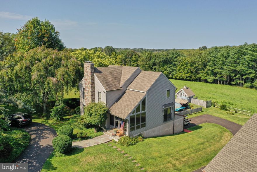 Welcome to Hidden Meadow, a beautiful country estate nestled in the heart of Tinicum Township.  Set far off a quiet country road this custom built contemporary style home is surrounded by open rolling fields and a mature wood line without a neighbor in site. Enter through the front door to a two story foyer filled with floor to ceiling windows filling the room with natural light, hardwood floors and custom trim work.  Step into the chef appointed kitchen with ten foot granite island. custom cabinets, stainless steel appliances,  commercial range, coffee station and an adjacent  sunlit sitting area. There is an expansive dining room with fireplace, hardwood floors, and recessed lighting. The addition of the 4 season sun room with custom built in bookshelves, cedar plank ceiling, a view over looking the pool and side door to the blue stone patio completes the main floor.  The upstairs provides a spacious primary suite with fireplace, 2 full baths and two more generous bedrooms.  The finished walkout lower level has a great room, built in cabinetry, a full bath, laundry room, oversized woodburning stove, French doors that open directly to the pool and an attached one car garage. The backyard is a private oasis with in-ground pool and spa surrounded by custom hardscaping, ornamental plantings and a mature landscape. The additional detached two car garage and well appointed dual guest quarters with full kitchen and bath for visiting friends and family complete this estate.  The view from each window is as it was a century ago, and invites you to be a part of it's whimsical disregard for the passing of time.  This country home combines modern luxury amenities & comfortable spaces with a scenic pastoral landscape that has come to define the Bucks County experience.  Easy access to Rt 611 & Rt 32 River rd. and Rt 78.  90 Minutes to NYC. 
A short drive to the Lehigh Valley, Doylestown & New Hope.  Schedule your tour today!