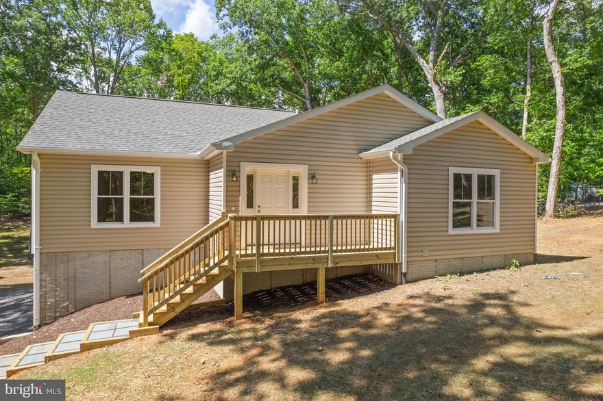 Newly Built Rambler is nestled on 1.96 mostly wooded acres. Foyer opens up  to open floor plan living room , dining room , kitchen with beautiful  hardwood natural white oak floors. Dining area leads out to 16x10 deck overlooking backyard . Kitchen has stainless appliances, granite countertops and hickory cabinets
Primary bedroom has walk in closet with  an   en suite. Walk in shower with separate tub. Vanity has double sinks, and water closet. Front porch has a roomly 14x5 deck. Full basement has rough in bath, plenty of room for your own personal design. Just a short walk there is Lake Anna complete with  cove and  boat ramp. Private key to gate. Comcast internet