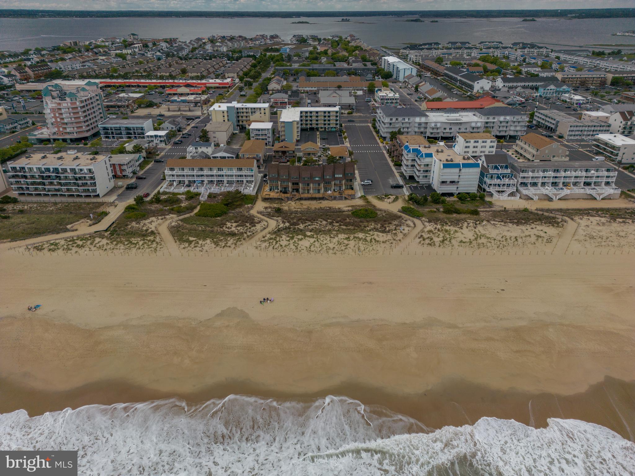 This beachfront property is a fantastic opportunity to purchase a fully-furnished vacation home with all the latest amenities. The four-bedroom and two-and-a-half-bathroom unit features modern accessories and designs, granite countertops, and immaculate carpentry throughout. The first floor boasts a large deck leading directly to the beach, a kitchen, a dining room, and a living room with a fireplace and an open floor plan. Upstairs, there are multiple rooms, including a master bedroom with an attached sliding screen door and upper deck with stunning ocean views. Additionally, there is an office space for the worker in the family, and previous owners had the home renovated in 2015, including new kitchen appliances, bathrooms, air conditioning, doors and hardware, railings, lighting, and ceiling fans. The floors were also replaced in 2018, and there are new windows throughout the unit. With a large garage and a prime location, this beach house offers a comfortable and spacious home away from home.