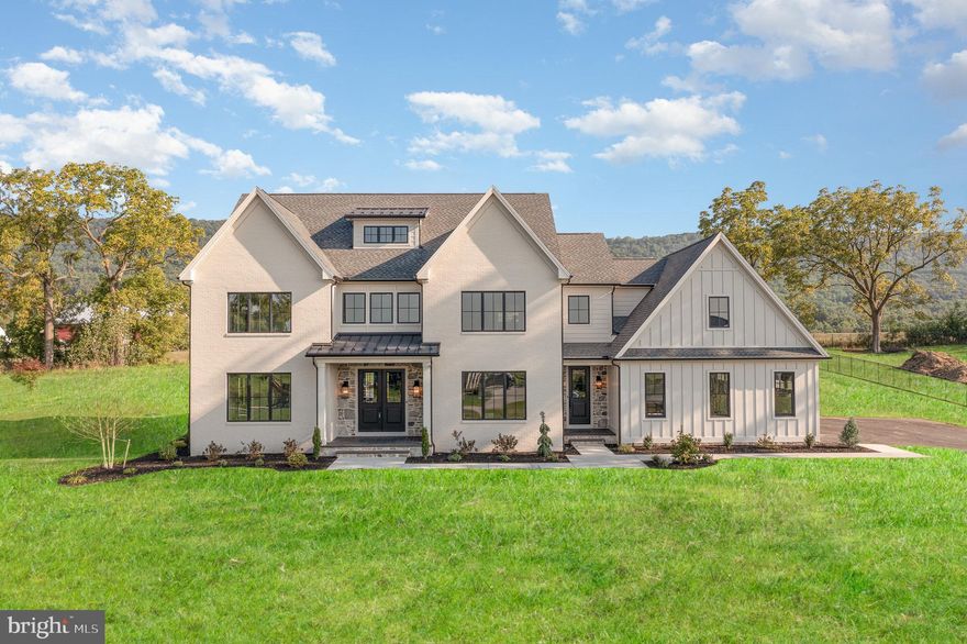 Imagine a home so flawless it feels as though it was crafted just for you—because it was. FoxBuilt  welcomes those who demand nothing less than the extraordinary, those who wish to embrace a lifestyle of unparalleled elegance and bespoke craftsmanship. Introducing 12 Blue Marlin Way, this 5-bedroom, 4-bathroom Modern Farmhouse is situated on a premier 0.92-acre lot in prestigious Glendale Estates within the coveted Cumberland Valley school district, and offers a sophisticated living experience. Step into a world of elegance where every detail has been meticulously crafted. The home features a stunning Modern Farmhouse design with white Hardie plank siding, painted brick, stone accents, and sleek black window frames. The inviting front porch with its herringbone brick pattern and majestic columns sets the tone for the grandeur inside. Enjoy breathtaking views of Blue Mountain from your expansive back patio, ideal for relaxation and entertaining. The grand foyer seamlessly flows into an open-concept living space with wide plank hardwood flooring, exuding warmth and sophistication. The spacious living room is bathed in natural light, creating an inviting ambiance. The gourmet kitchen is a chef's paradise, boasting quartz countertops, high-end appliances, creative custom designs, and  stylish beverage center. The custom range hood and pantry, complete with a coffee bar, make this kitchen both beautiful and practical. Adjacent to the kitchen is an elegant dining room, ideal for hosting memorable dinners. A versatile office/5th bedroom, complete with a walk-in closet and full bath, offers flexibility for your lifestyle needs. The powder room features a unique vanity, adding a touch of charm. The mudroom hallway with its all-brick ceiling and arched wood doors leads to a spacious three-car garage. Ascend to the second floor where luxury and comfort converge. The primary suite is a private retreat featuring a spa-like en-suite bathroom with a wet room shower, two expansive vanities, custom recessed cabinets, and a toilet room with its own additional sink. The master suite also includes a fully stacked walk-in closet, tailored for those who expect the best and finest. Three additional bedrooms, each with access to well-appointed bathrooms, provide comfort and privacy for family and guests. A cozy sitting area and a conveniently located laundry room complete the second floor. The third floor is a versatile space designed to suit your lifestyle needs. The expansive loft area is ideal for a game room, home theater, or additional living space. A utility room provides extra storage, while a well-designed bathroom and functional hall space ensure practicality. The full basement extends your living space, featuring a large recreational area perfect for kids to spread out, play games, or relax. The bonus room is ideal for a home gym or crafting room. Ample storage space, a rough-in for a basement bathroom, and a grand concrete exterior staircase add to the cool basement's appeal. Built with state-of-the-art materials and technology, this home includes Superior Walls foundation, top-shelf well & septic systems, and 400-amp electric service. Smart home technology, separate heating systems, and premium finishes such as custom cabinetry, designer lighting, and hardwood floors sanded and stained on site enhance the home’s appeal. Exterior features include composite trim for low to zero maintenance, a painted brick mailbox that foreshadows quality and luxury within, and an enviable landscape package. If you wish to indulge in a residence that redefines the meaning of perfection and prestige,  where every detail is designed to delight the discerning eye, contact us for your private tour experience. You will not be disappointed.