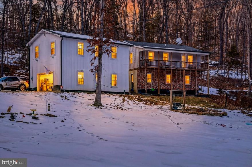 Welcome to peaceful country living with room to grow! This spacious raised ranch offers 4 bedrooms and 2 full baths, perfectly situated on 5.1 beautiful acres of privacy and possibility.

Step inside to find a functional and inviting layout with living space for family gatherings or quiet evenings at home. The main level provides 2 comfortable bedrooms and full bath, offering flexibility for families, guests, or home office needs.  The lower level offers an additional 2 bedrooms, full bath and laundry room with private entry from outside.

Enjoy your morning coffee or evening sunsets on the full-length front porch that spans the entire home—an ideal spot for rocking chairs and relaxing views. Out back, a deck wraps around to the side of the home, creating the perfect setting for entertaining, grilling, or simply enjoying the peaceful surroundings. The backyard offers privacy and open space to explore, garden, or play.

Car enthusiasts, hobbyists, or those dreaming of additional living space will love the detached 2-car garage featuring a loft area above that is already framed and ready for your vision. Whether you imagine a guest suite, studio, home office, or recreation space, the framework is in place for you to bring your ideas to life.

With acreage, privacy, outdoor living spaces, and expansion potential, this property offers the perfect blend of comfort and opportunity. Don’t miss your chance to make it your own!