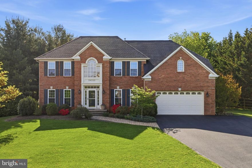 Check out the virtual tour for Hailey Drive—an exceptional colonial nestled in the highly sought-after Kings Valley Manor community. Boasting over 5,000 square feet as the largest model on the street, this stunning 4 bedroom 3.5 bath home offers beautifully designed living space that impresses from the moment you arrive. Step inside to a grand two-story foyer with a dual staircase, flanked by formal living and dining rooms—perfect for elegant entertaining. The heart of the home is the warm and inviting family room, featuring expansive windows that flood the space with natural light and offer serene views of the private backyard. Designed for both everyday living and effortless entertaining, the main level includes a gourmet kitchen with a massive island and granite countertops, a dedicated home office with French doors, a butler’s pantry, a spacious main level laundry room, and a convenient powder room. Upstairs, retreat to the luxurious primary suite featuring tray ceilings and a spa-like bath with dual vanities, a soaking tub, and a walk-in shower. Two generous walk-in closets provide plenty of storage. Three additional bedrooms and two full baths—including an en-suite—offer comfort and flexibility for family and guests alike. The fully finished basement expands your living space with a custom bar and endless possibilities—perfect for movie nights, game days, a home gym, or playroom. A bonus room offers potential for a fifth bedroom, and abundant storage ensures everything has its place. Situated on a flat almost three quarter acre lot backing to protected woods, the backyard lives larger than most—creating a true private retreat. Enjoy outdoor living at its finest with a deck, charming pergola, and patio—ideal for entertaining or unwinding in a peaceful setting. Don’t miss the basketball court and firepit! Additional highlights include a two-car attached garage, ample driveway and street parking, and a quiet no-through street location. Enjoy convenient access to nearby commuter routes and local favorites like Butler’s Orchard, Damascus Regional Park, Jimmie Cone, and Doc Waters Cidery.  With its premier lot, expansive layout, and rare availability within Kings Valley Manor, early showings are strongly recommended. Homes of this caliber do not come to market often—don’t miss your opportunity to make it yours today!