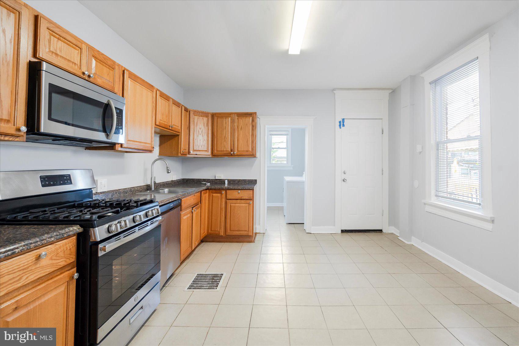 Newly refreshed 3BR/1BA end of row Townhome located on a quaint tree-lined street. Make your way to the covered front porch and open the door into your new home. Inside you will find a freshly painted interior, tons of natural light, and easy care flooring. The main floor offers an open floor plan featuring a spacious living room, sizable dining room, kitchen, and laundry room/pantry. The kitchen offers plenty of cabinets and counter space, stainless steel appliances, and a deep stainless sink. Tucked behind the kitchen is the laundry room with tons of space for storing pantry items. On the second floor are two sizable secondary bedrooms, a spacious primary bedroom, and a full bath with a walk-in shower. The lower level is unfinished, clean and dry offering the opportunity to create additional living space for your family's needs. From the kitchen step outside to a fenced yard with a large patio area ideal when entertaining family and friends. This home is move-in ready with so much to offer new homeowners, and is located in close proximity to shopping, restaurants, and commuter routes.