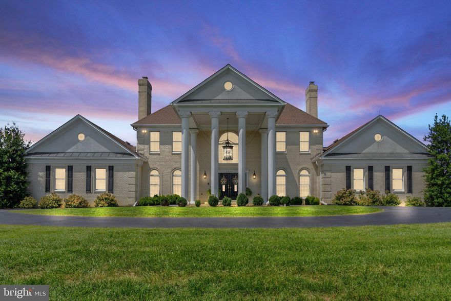 From the moment you arrive at this property, you know you are in a special place. Driving between the stone columns and greeted by the cheerful purple hues of the blooming Crape Myrtle’s—you start to get that excited feeling. This one could be it. The one you’ve been waiting for. And it just gets better from here. 
Welcome to Feisty Fox Farm, a home that combines luxury living with the tranquility of country life. The stately all brick 6000sf manor home is located on over 10 acres of land, incorporating both a boutique vineyard and a horse farm, offering the perfect blend of elegance and practicality.
Inside, the gracious two story foyer with carrera marble floors and dramatic dual curved staircases sets the tone for the elegance within. The formal living room, with its cozy fireplace, the wood paneled office, with oak built-ins and the large dining room, also with a fireplace, all showcase extensive interior trim details. In total, the home contains five fireplaces. 
The gourmet kitchen is a chef's dream, boasting a built-in Miele refrigerator, full size freezer, coffee maker, a gorgeous ILVE 7-burner stove, and a full-size built-in wine chiller. The window over the farmhouse style sink offers pastoral views of grazing horses, while the oversized island with wood top seats four in addition to the seating available in the breakfast room. The quality cabinetry with inset doors and soft close hardware along with the brick backsplash add to the kitchen's charm.
From the kitchen, enter the large great room with vaulted ceilings, wet bar, stone fireplace with catalytic woodstove insert and elegant Palladian windows and French doors that open onto an enormous deck with gazebo. 
The functional but beautiful laundry room and mudroom feature brick floors, custom wood countertops, a front load washer and dryer, and a laundry sink. 
The main level also features a luxurious primary bedroom suite, offering comfort and privacy. The suite includes two spacious walk in closets with custom closet designs and a sumptuous en suite bathroom that rivals any luxury spa. 
Upstairs, the large upper foyer with built-ins is the perfect spot for a piano or music room, or maybe a great homework area. A second primary bedroom suite along with two other spacious bedrooms and a hall bath complete this level.
The lower level offers a large recreational room with a wood burning fireplace, a gym space with a dry sauna, and a full bathroom. There is also a multi-purpose room with an en-suite updated bathroom, perfect for guests.
Outside, the estate features 1.5 acres under vine. 100% of this acreage is planted in Vidal Blanc, which has proved to be a versatile grape and grows well in Virginia. Horse enthusiasts will appreciate the four-stall barn with tack room and space for expansion. The well tended paddocks and spacious fields are ideal for equine companions.
The beautifully landscaped grounds offer numerous places to enjoy the outdoors. An expansive deck across the back of the house features multiple seating areas, a hot tub, and stairs to the ground level patio with a large outdoor wood burning fireplace. The three-bay detached garage is perfect for equipment storage or managing the vineyard.
Feisty Fox Farm is conveniently located near major commuting routes, Dulles International airport, shopping centers, wineries, breweries, and restaurants.