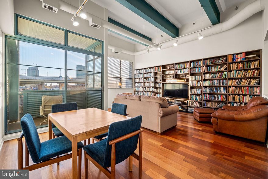 Experience the perfect blend of modern living and historic charm at Pier 3 Condominium! This stunning 1-bedroom with den unit is perfectly positioned facing south, providing breathtaking views of Penn’s Landing and the Delaware River. Enjoy a lifestyle of luxury with an array of top-notch amenities, including a 24-hour doorman, a heated indoor pool, a fitness center, convenient elevators, and secure parking on the lower level, complete with electric car charging stations.

Your monthly fee ensures hassle-free living, covering all maintenance services such as snow removal, trash collection, and exterior upkeep, so you can focus on enjoying your home. THIS UNIT'S SPECIAL ASSESSMENT HAS BEEN PAID OFF, PROVIDING LOWER MONTHLY COSTS AND ADDITIONAL VALUE TO A POTENTIAL BUYER,

Step inside to discover an inviting open floor plan featuring elegant wood and ceramic flooring throughout. The modern, custom kitchen boasts an open bar that seamlessly connects to the living room, making it a perfect space for entertaining friends and family. Two sleek modern bathrooms and in-unit laundry facilities provide comfort and convenience. Soaring high ceilings amplify the unique industrial character of the building while large windows bathe the unit in natural light. Unwind on your private balcony, taking in the picturesque views that surround you. Don't miss this opportunity to make this extraordinary place your own today!